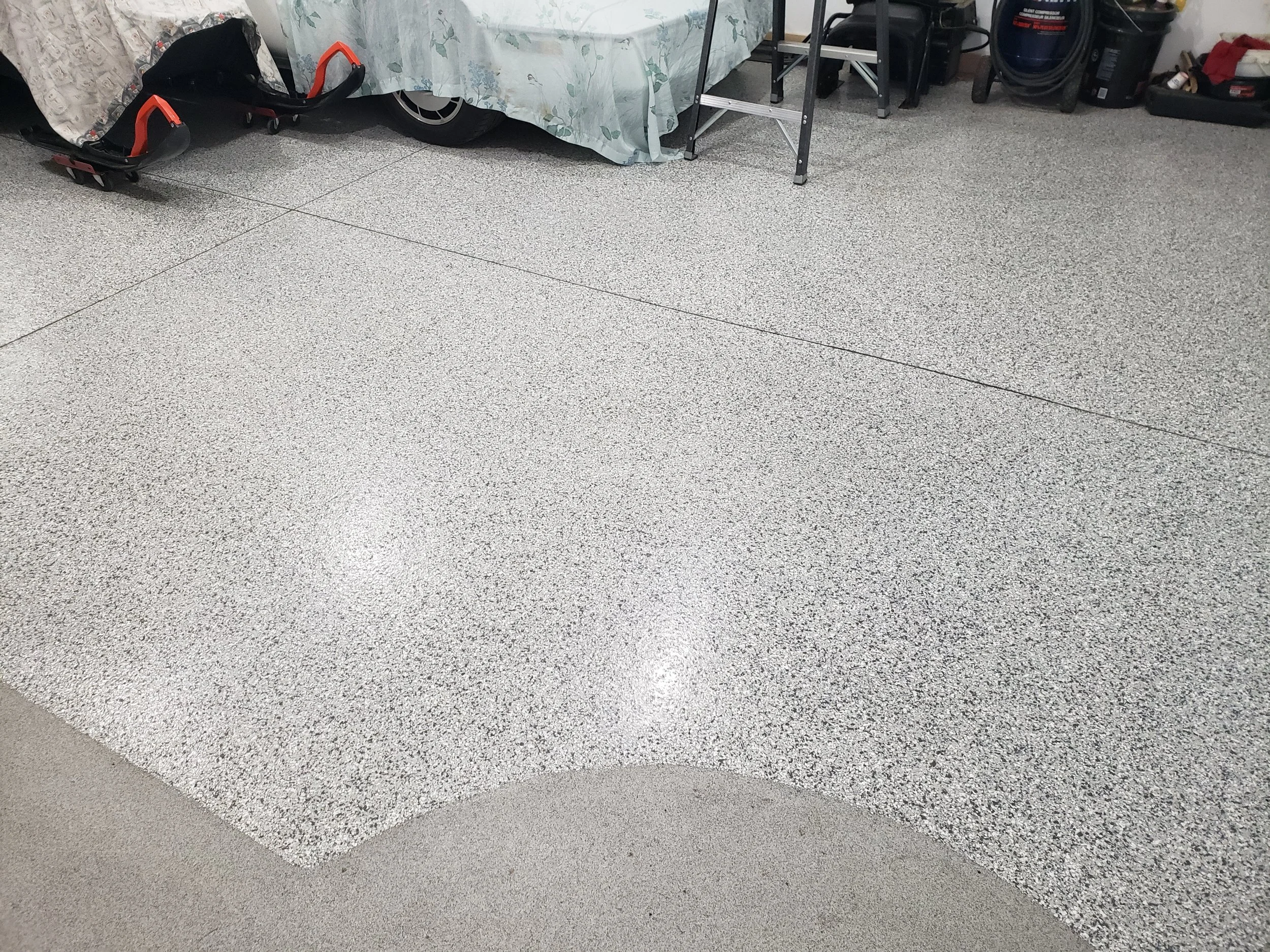 Garage floor finished in a full flake broadcast with anti-slip quartz stone by man door. 