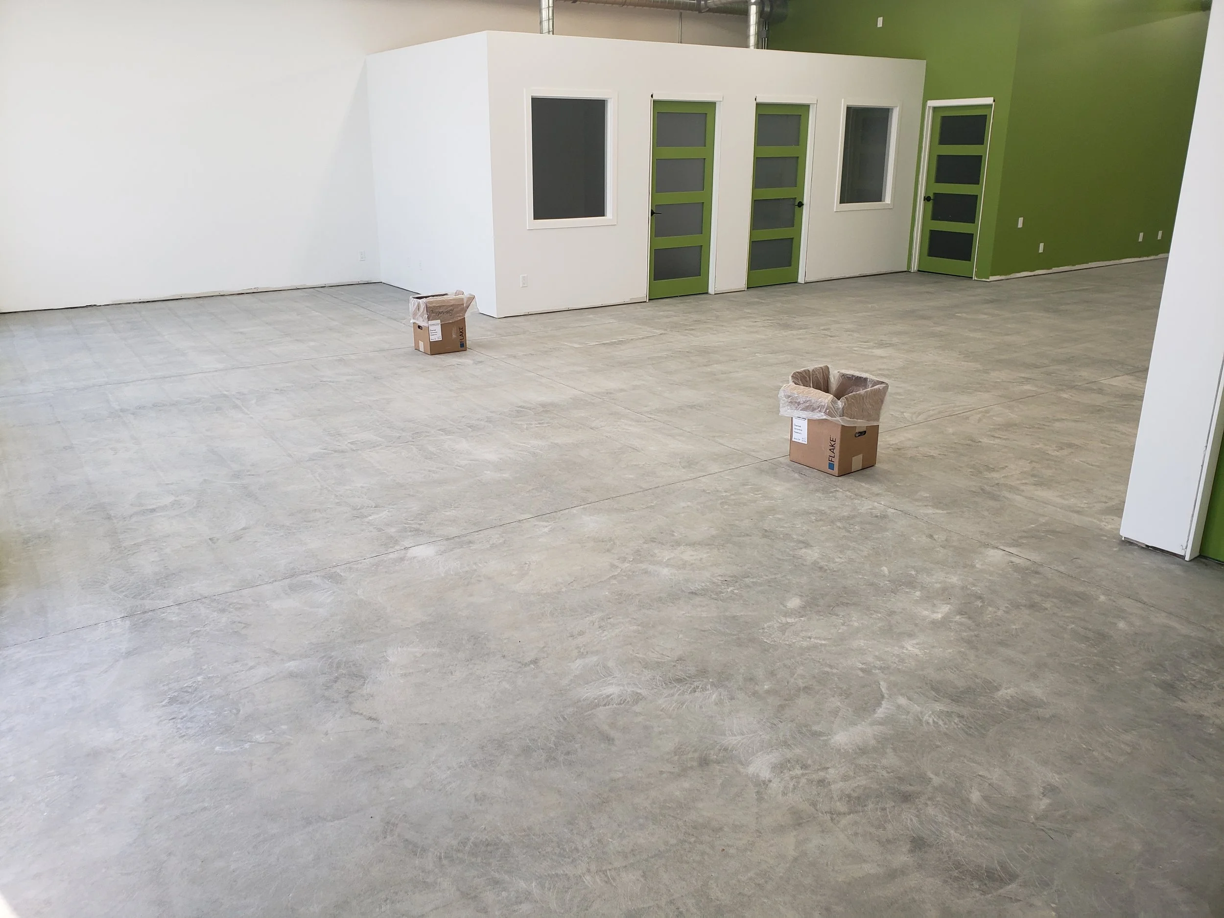 BEFORE - Bare concrete grinded and repaired.