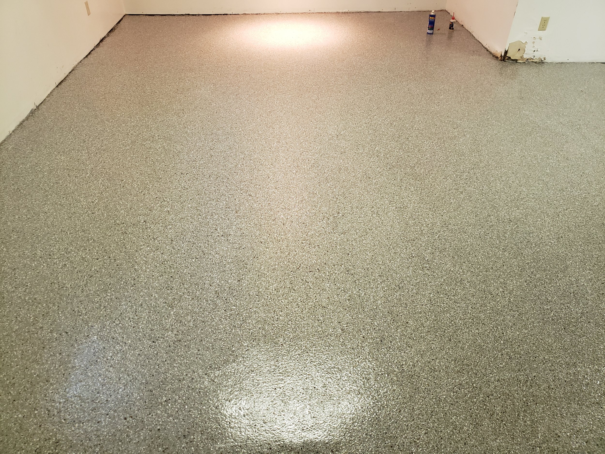 Finished basement floor. Coated in full flake broadcast polyaspartic. 