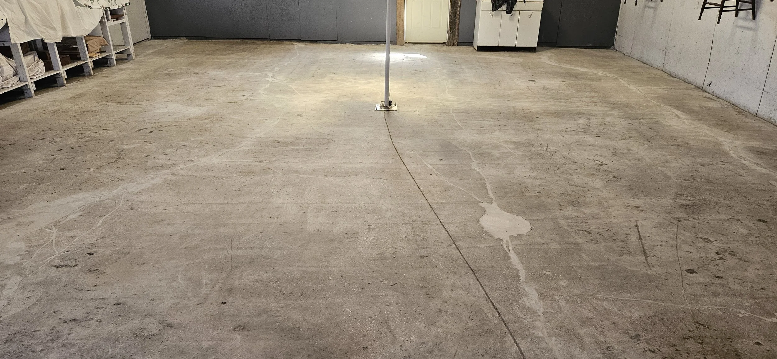 BEFORE - Bare concrete grinded and repaired.