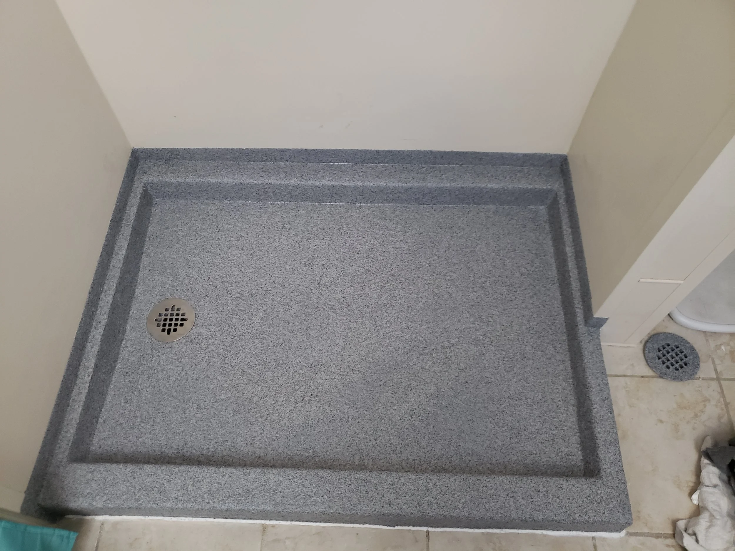 Finished shower floor. Anti-slip quartz stone polyaspartic. 