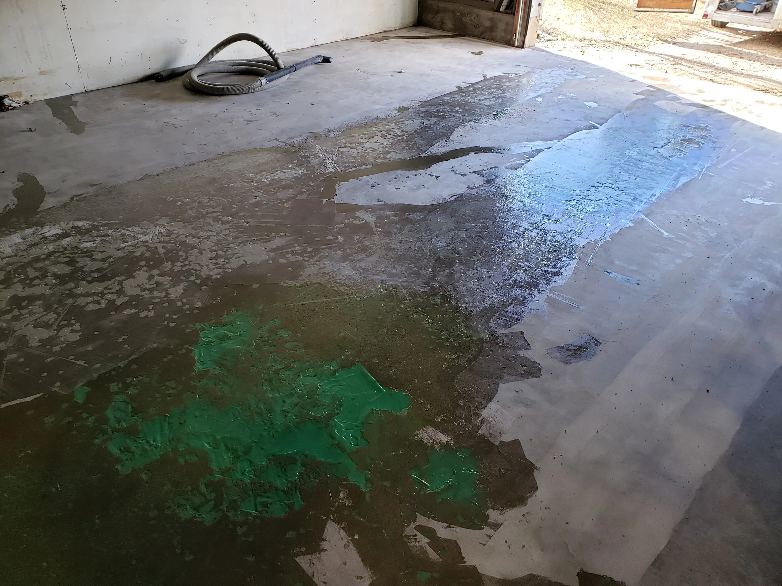 BEFORE - Bare concrete grinded and repaired. Sectioned off areas