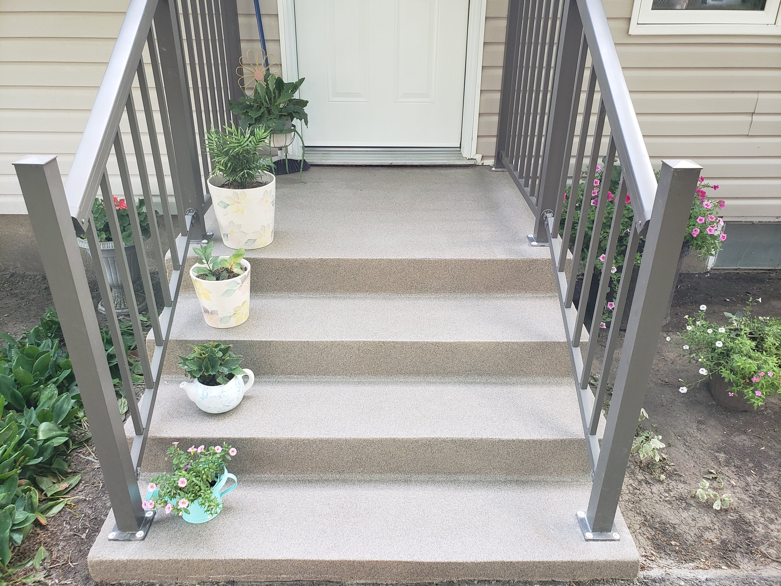 Concrete front step, finished in polyaspartic quartz stone, anti-slip good for winter months. 