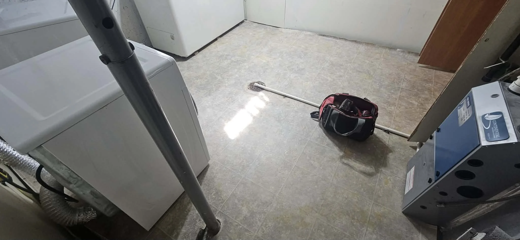 BEFORE - Laundry room with linoleum flooring. 