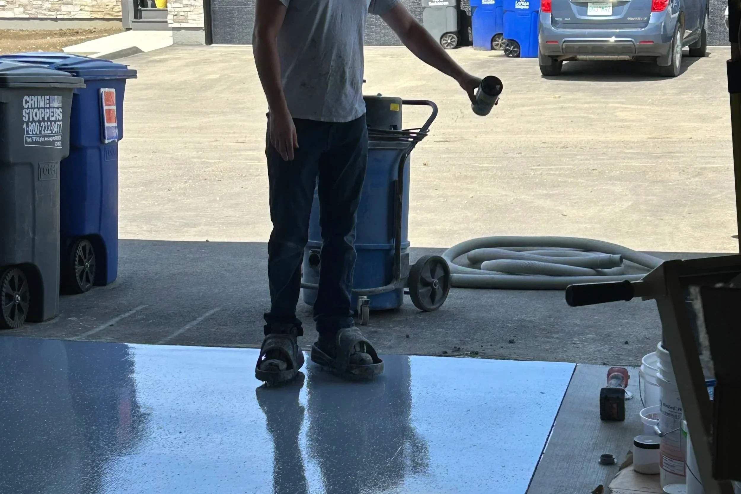Brandon Holder applying flakes to polyaspartic coating.