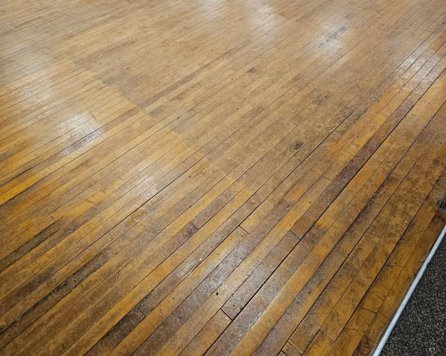 Hardwood floor needing refinishing.