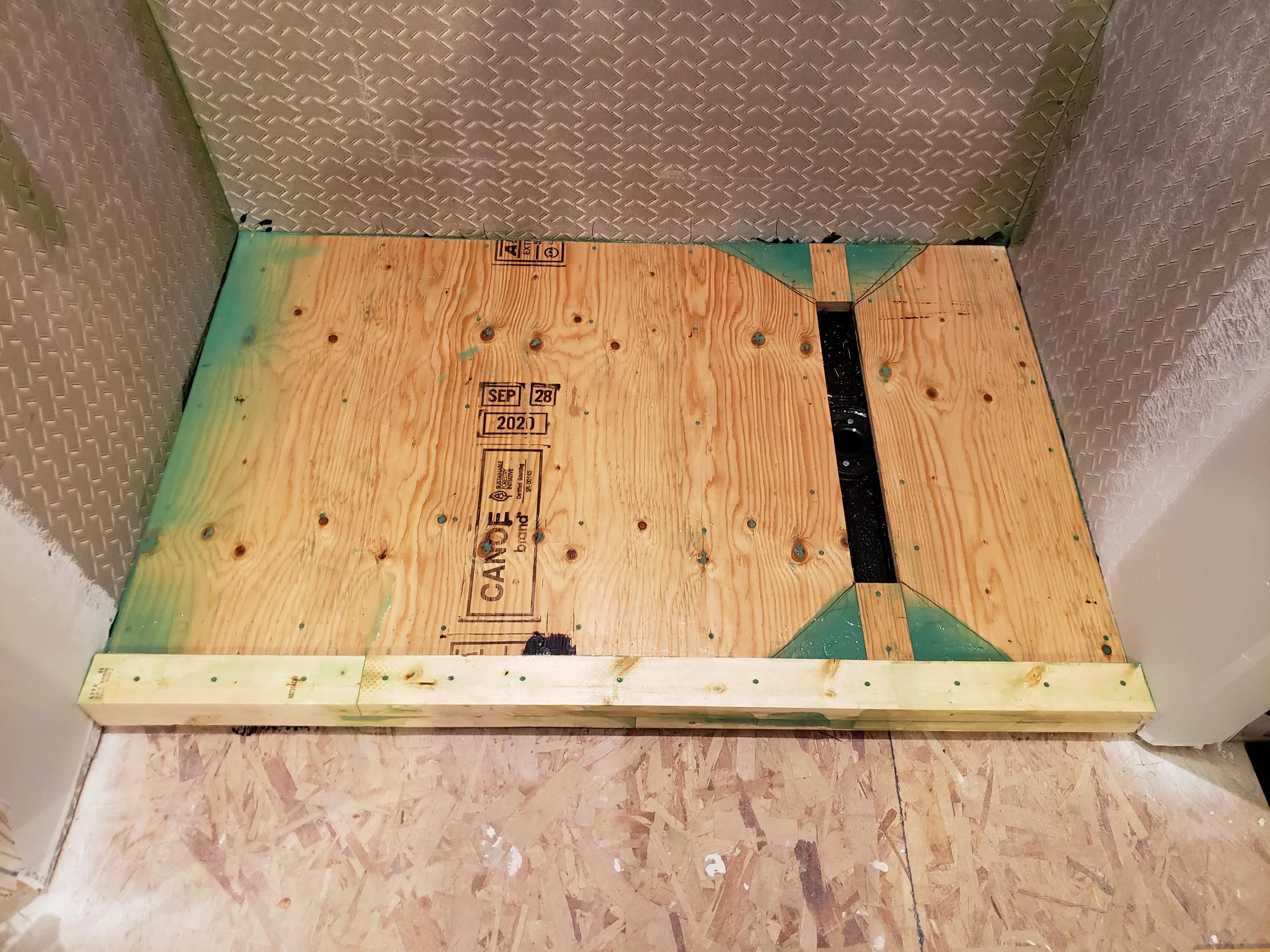 New shower floor, seams filled and smoothed, ready for coating. 
