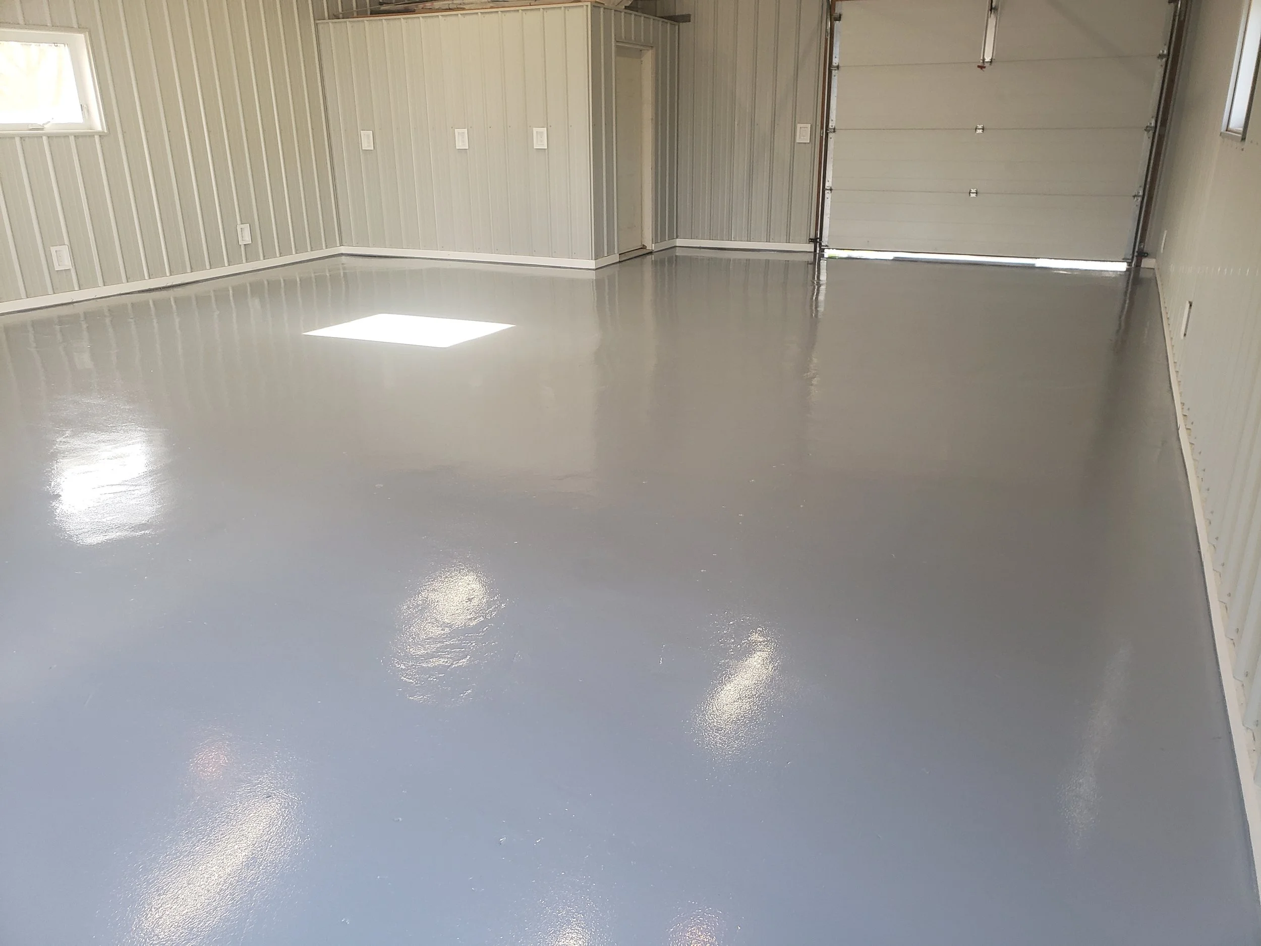 Garage floor coated in polyaspartic solid base grey. 