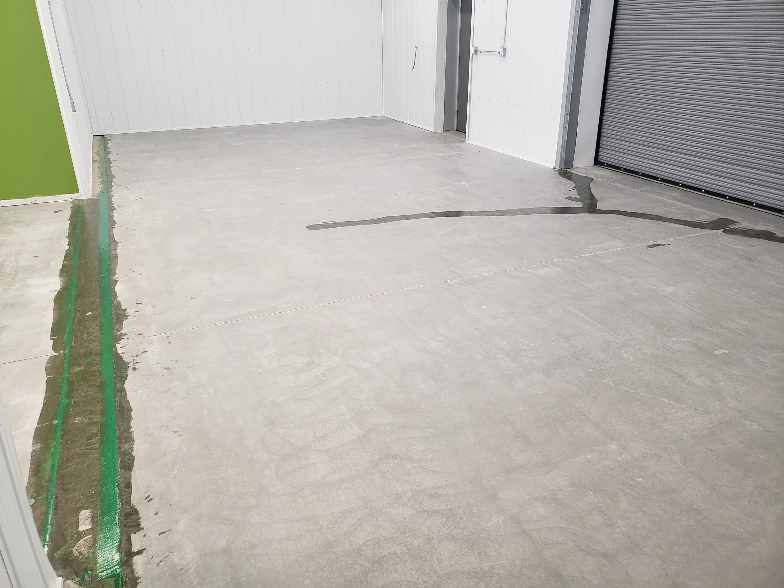 BEFORE - Bare concrete grinded and repaired.