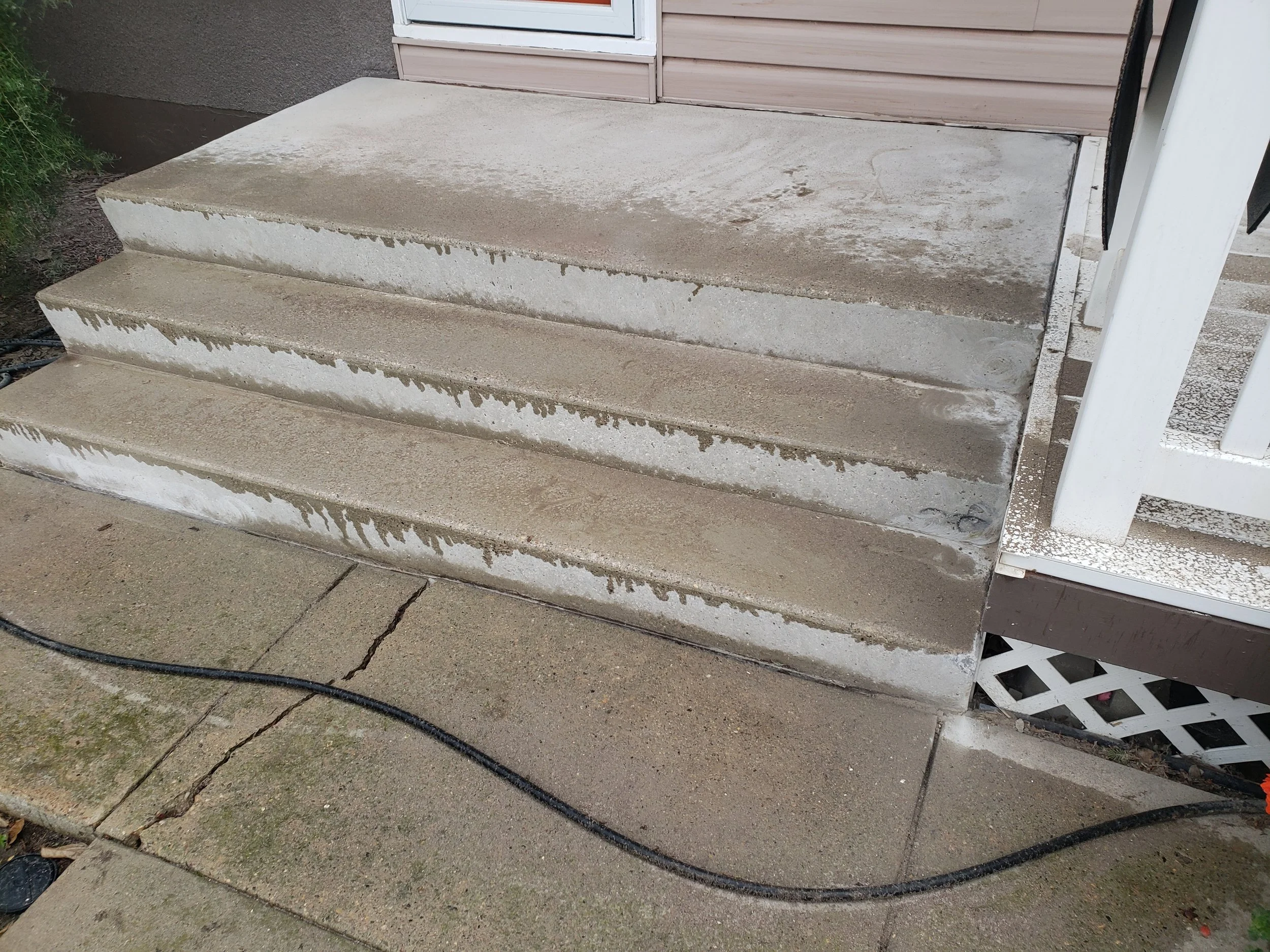 Concrete front steps grinded and repaired. 