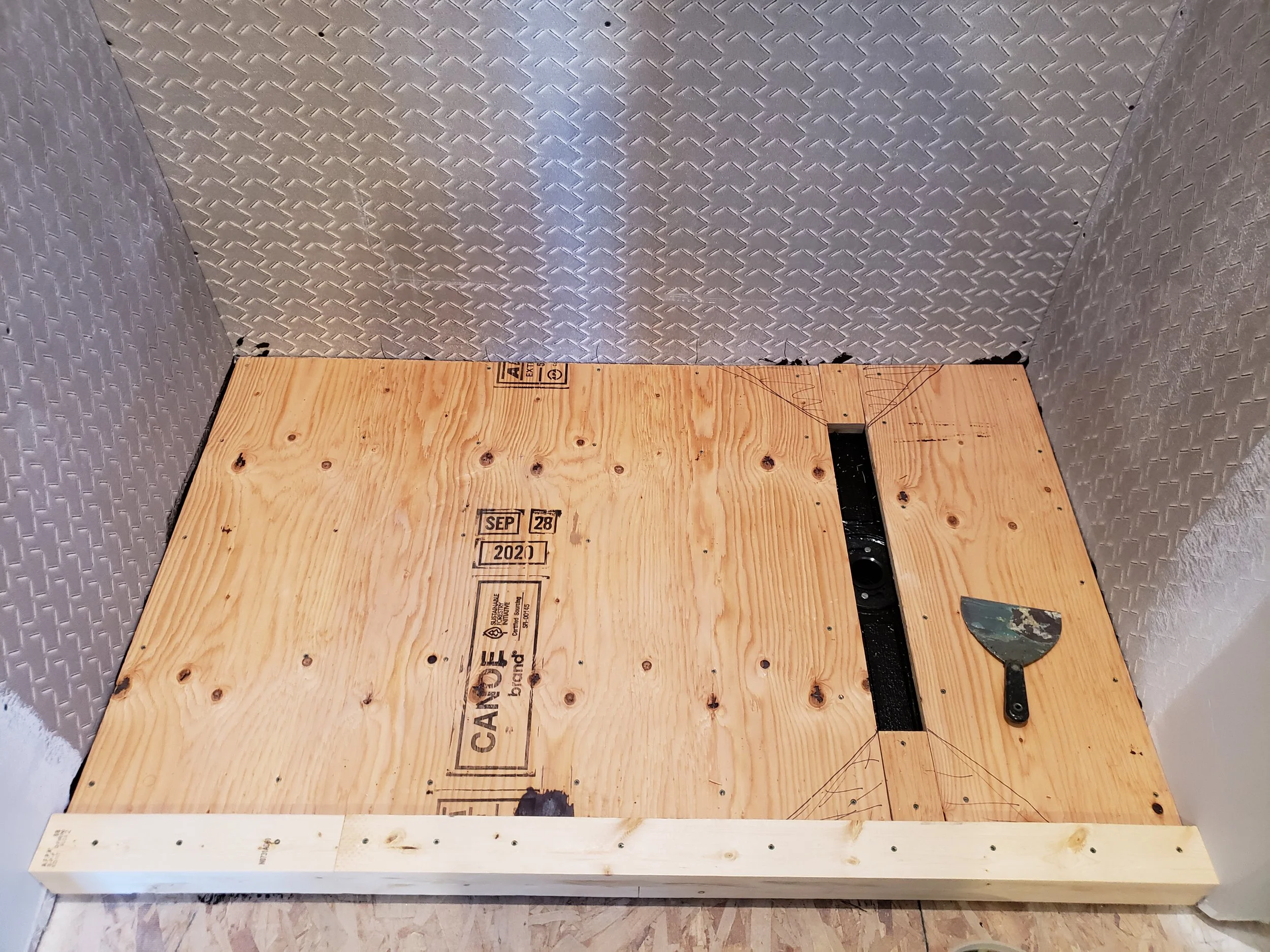 New shower floor, bare plywood.