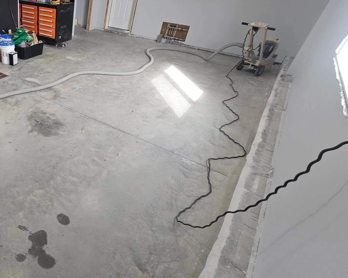 Garage floor project, grinding in progress before polyaspartic coating.