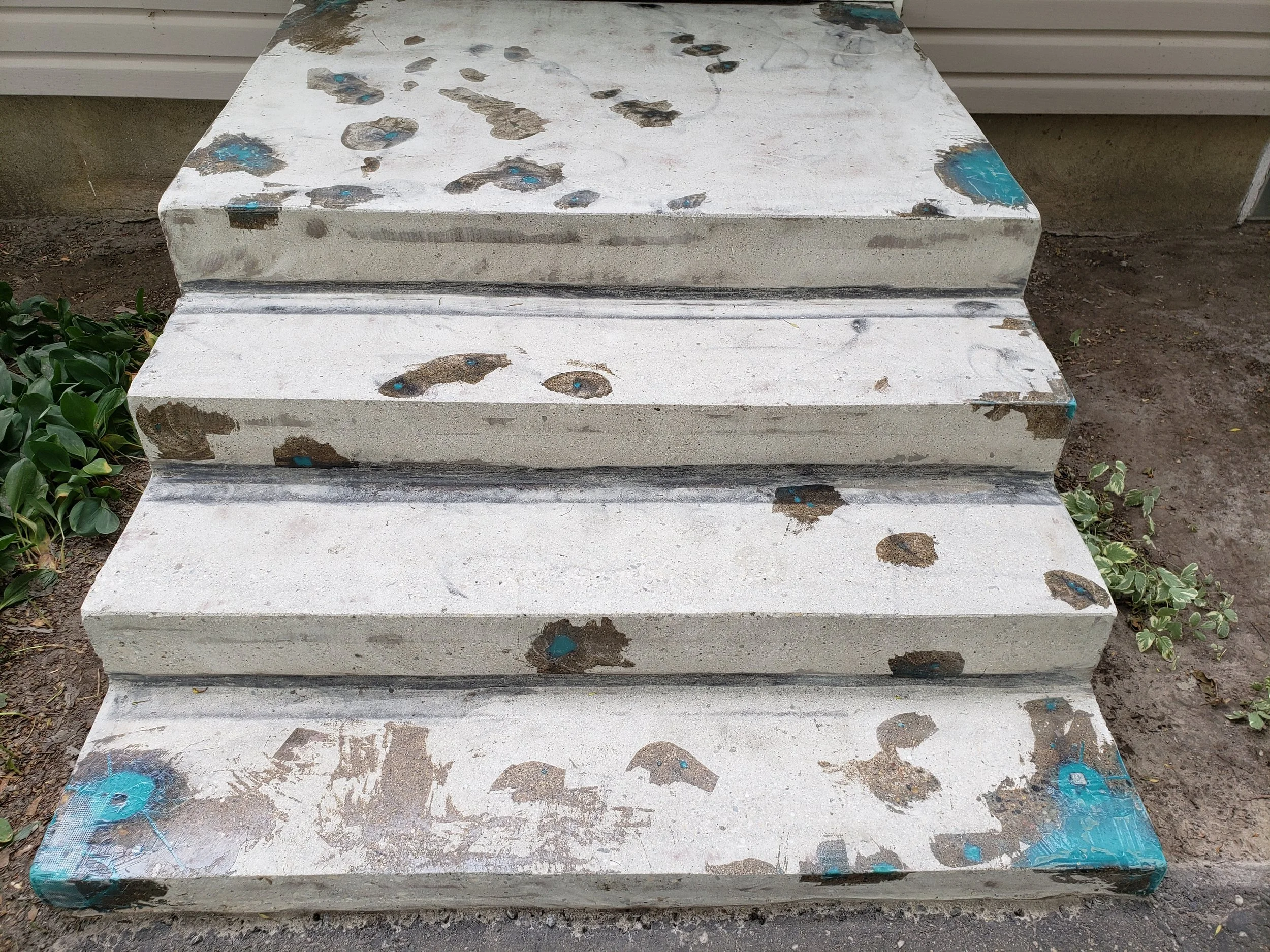 Concrete front step, grinded and repaired, ready for coating. 