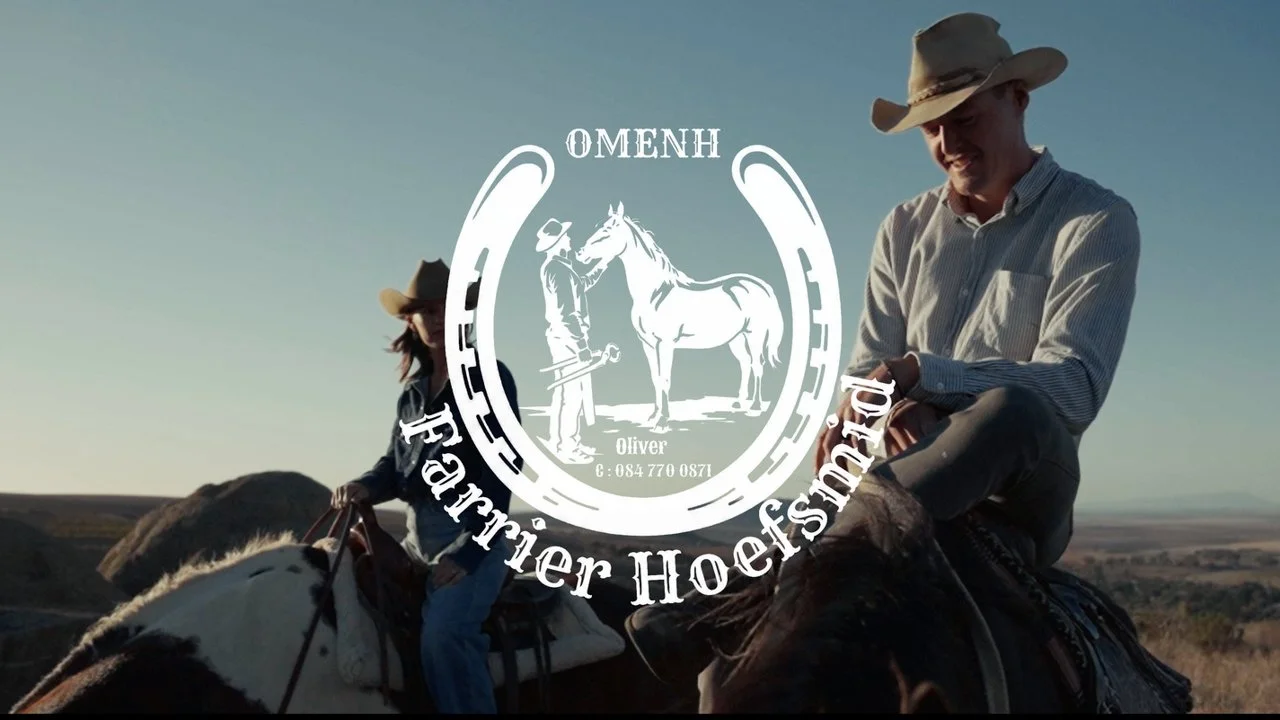 Two people riding horses outdoors, one man smiling, both wearing cowboy hats, with a landscape of open fields and hills in the background. An overlay graphic features a horse and rider, with the text 'OMENH' and 'Farrier Hoefsmeder'.