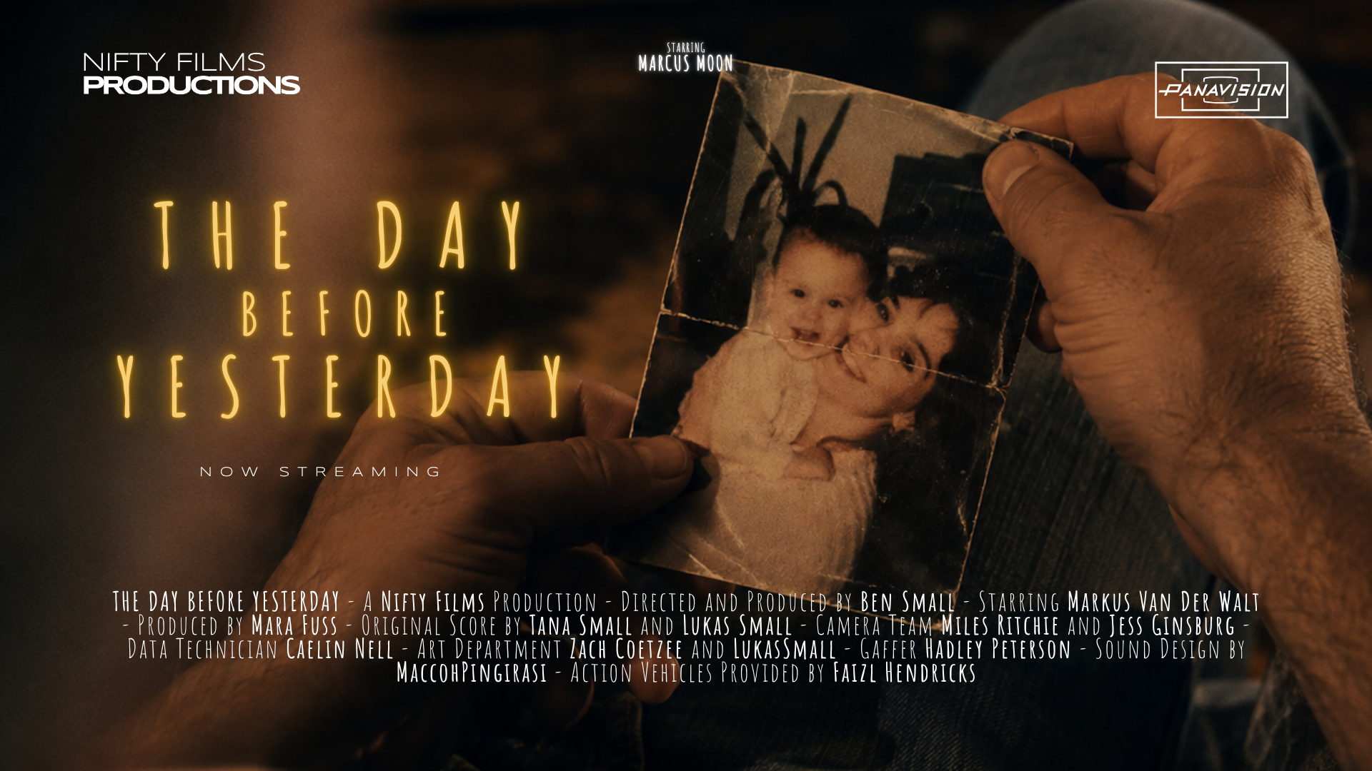 A hand holding a worn, slightly torn photograph of a smiling woman and a child, with the title 'The Day Before Yesterday' in glowing yellow font, and film credits at the bottom.