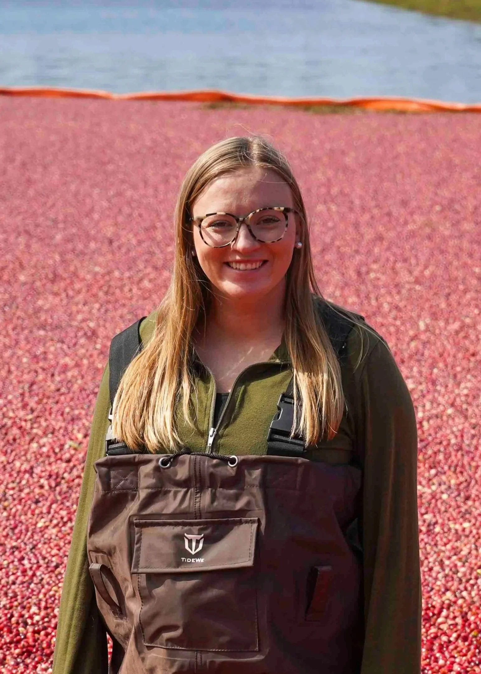 Headshot of Gabby Myers standing in a cranberry bed with floating cranberries