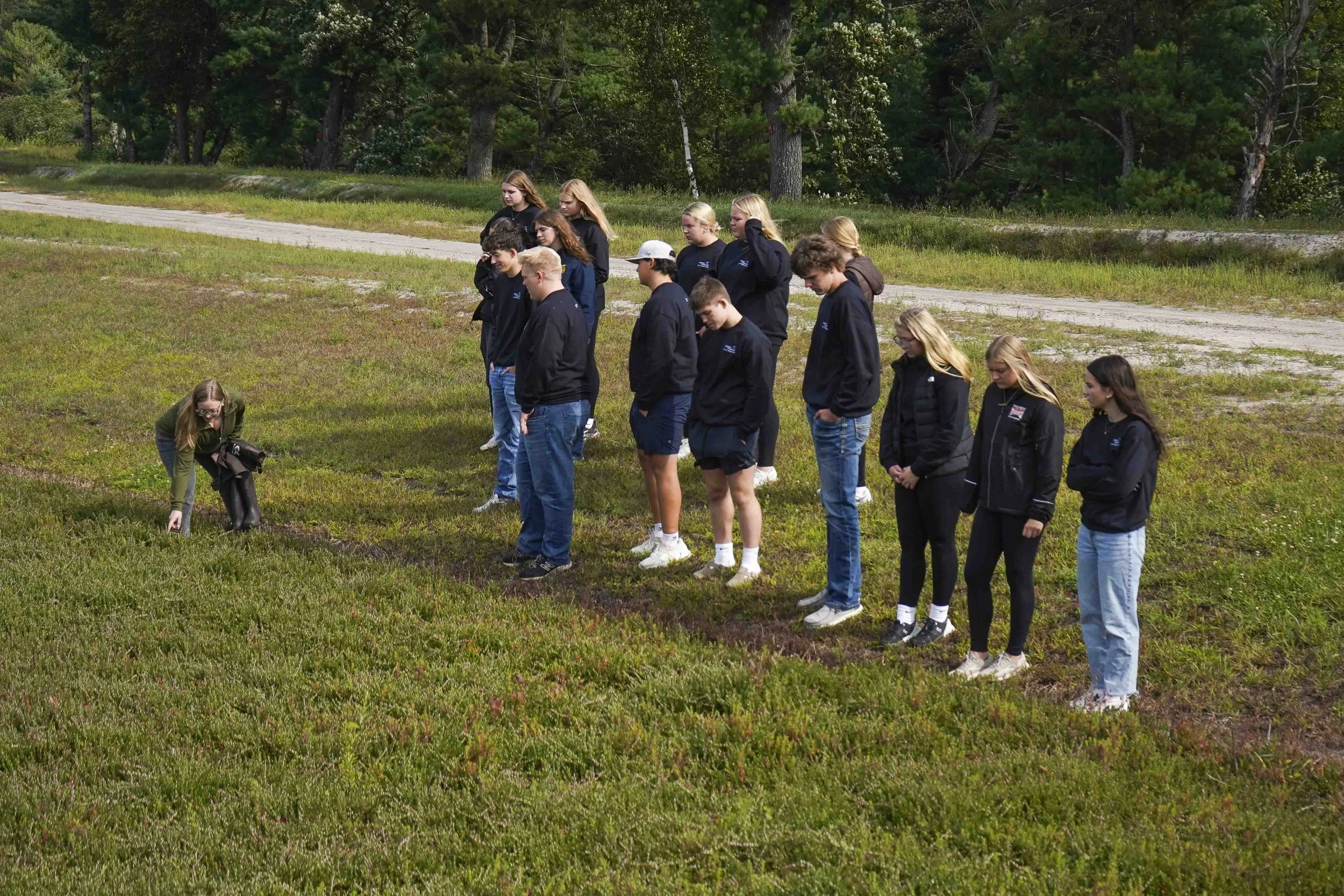High school tour looking at a cranberry bed