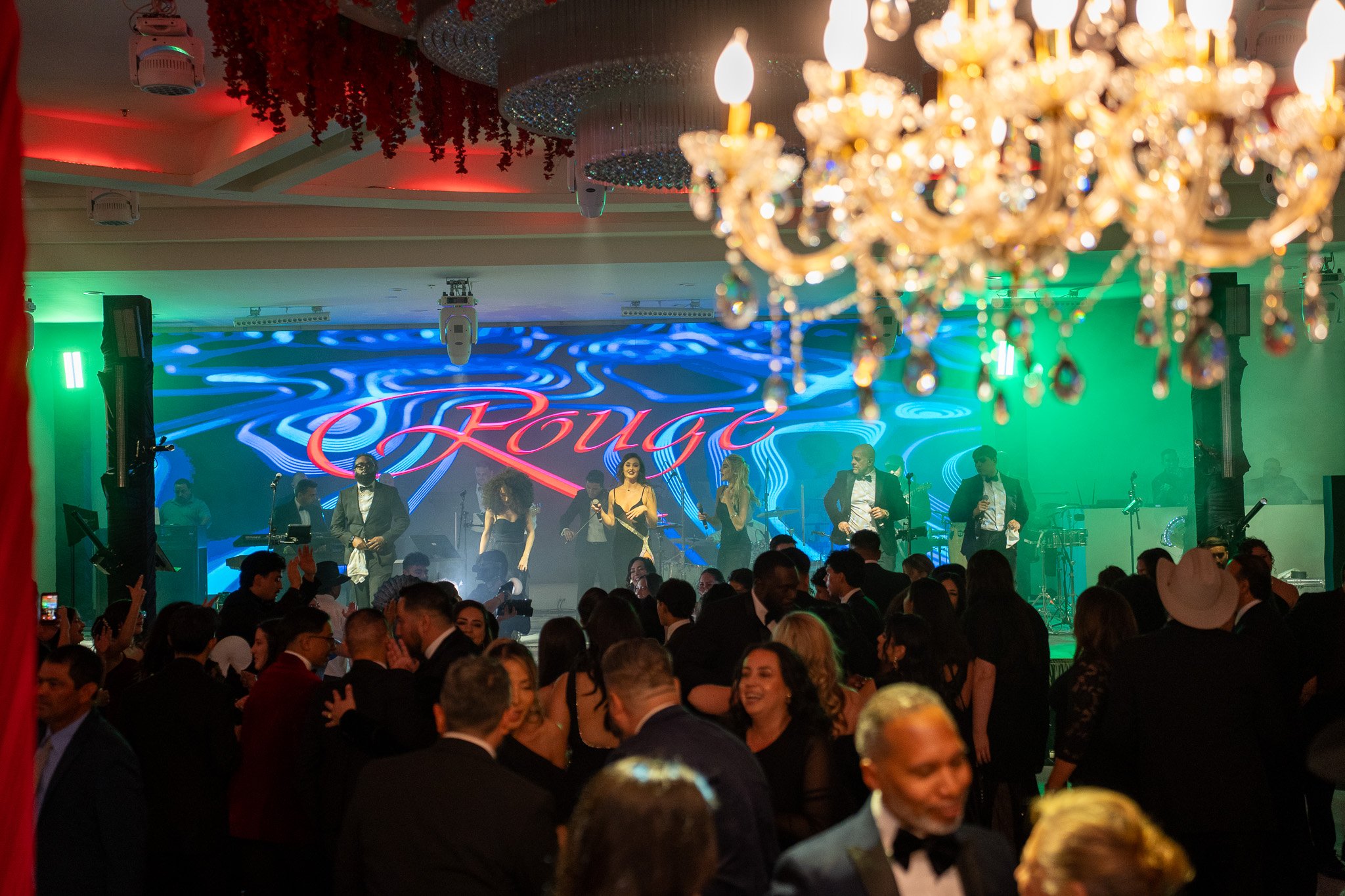 A lively party scene with a band performing on stage.