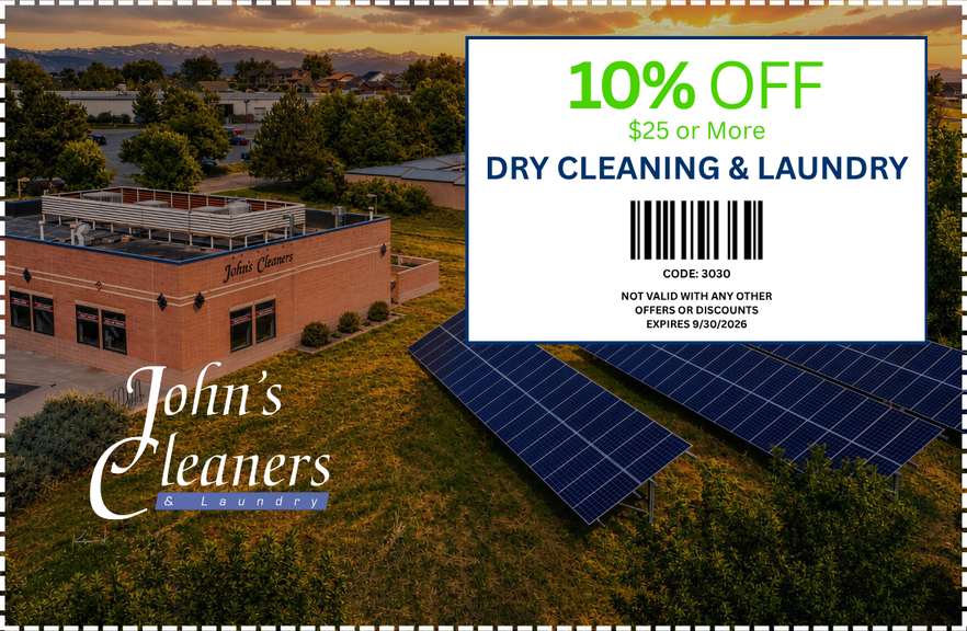 Aerial view of a commercial building with solar panels on the roof and a sign for John's Cleaners & Laundry, with promotional coupon for 10% off dry cleaning and laundry services.
