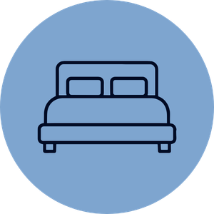 Icon of a bed with pillows inside a blue circular background.