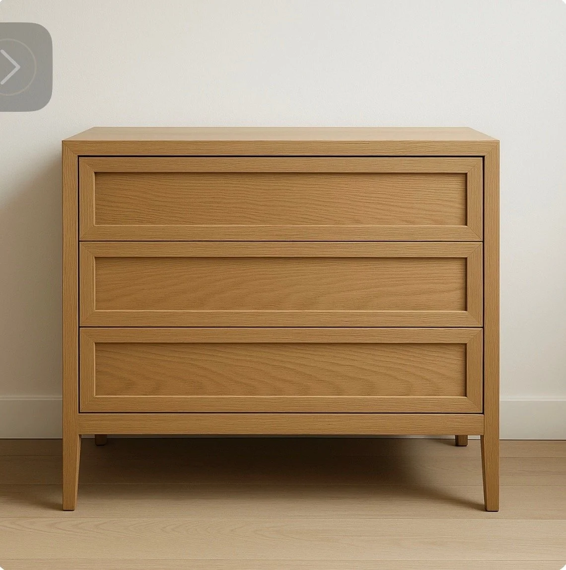 A light wood three-drawer dresser against a white wall.
