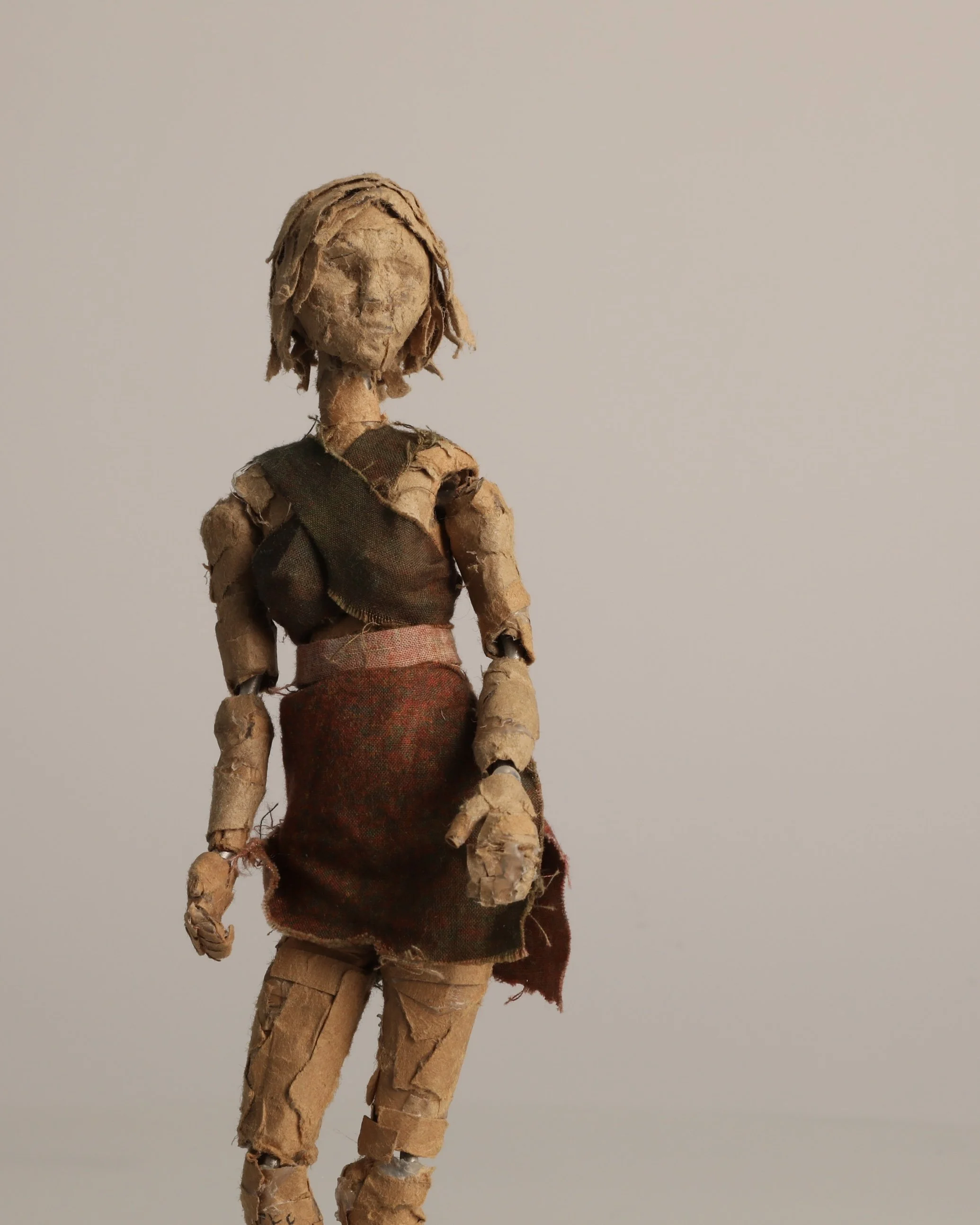 a cardboard sculpture resumbling a woman with short hair