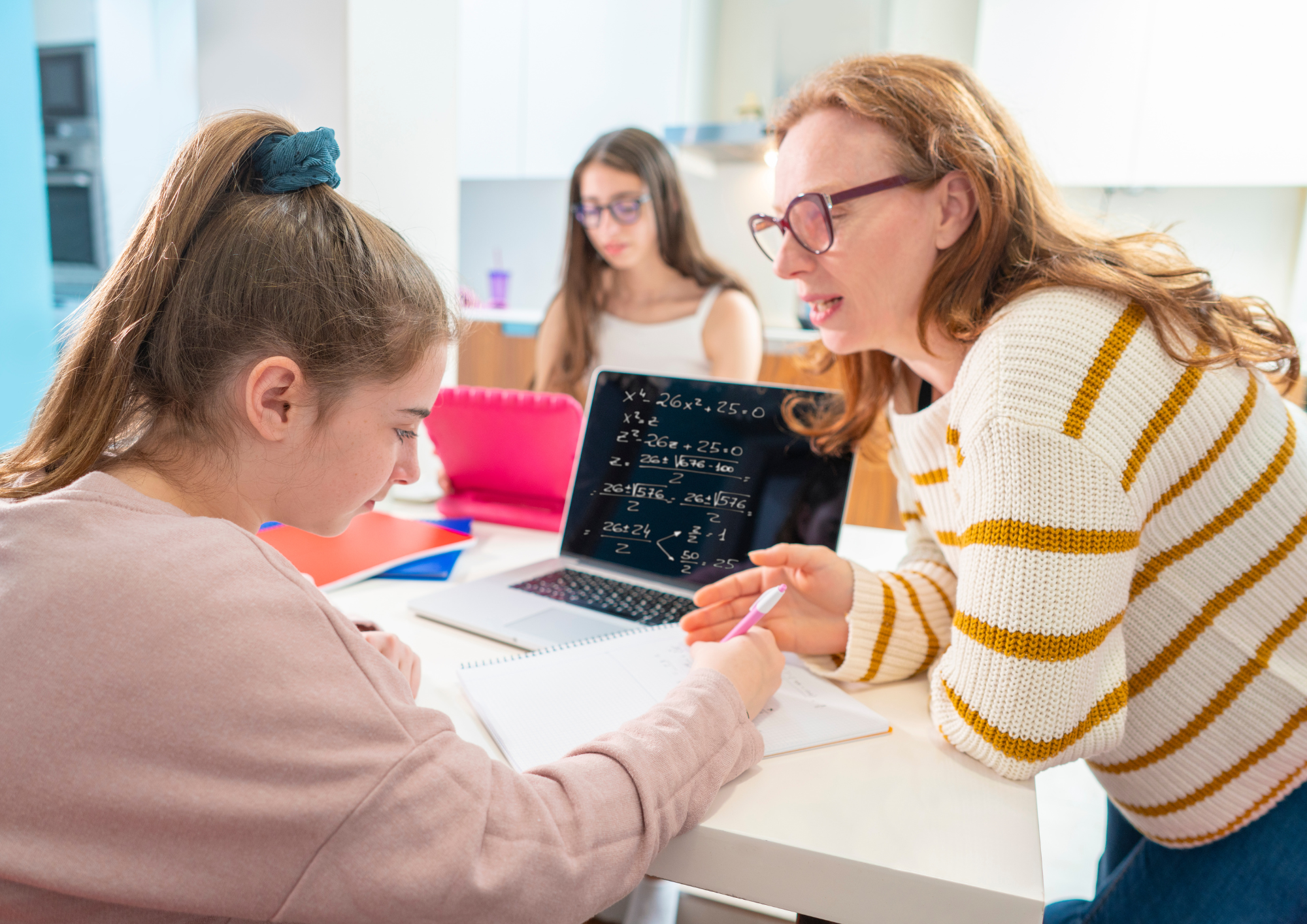 Homeschool parent working with a student during a personalized learning session.