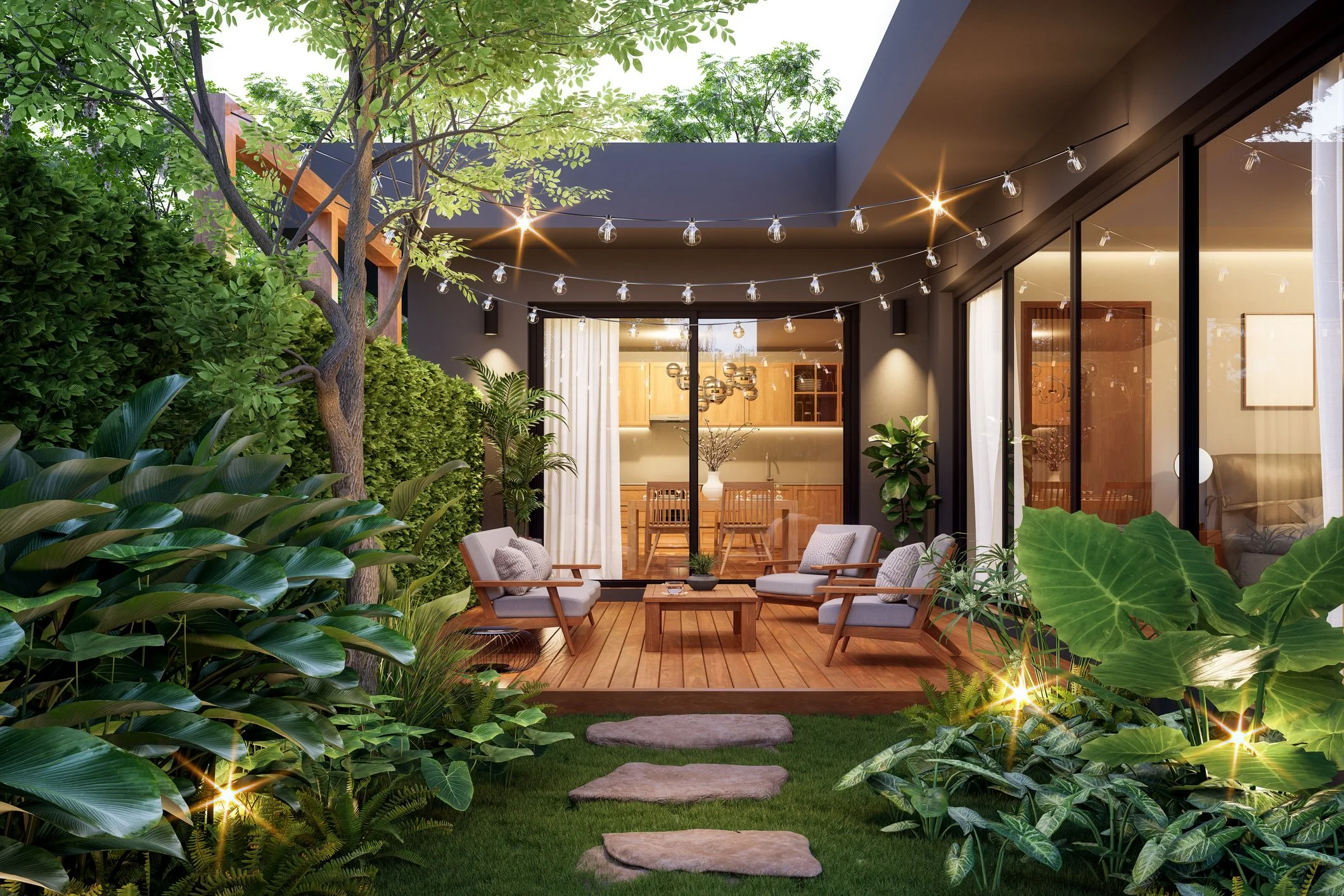 A cozy outdoor patio area with modern furniture, string lights, surrounded by lush green plants, trees, and a well-maintained garden. There are stepping stones on the grass leading to the patio, which is part of a contemporary house with large glass doors and warm interior lighting.