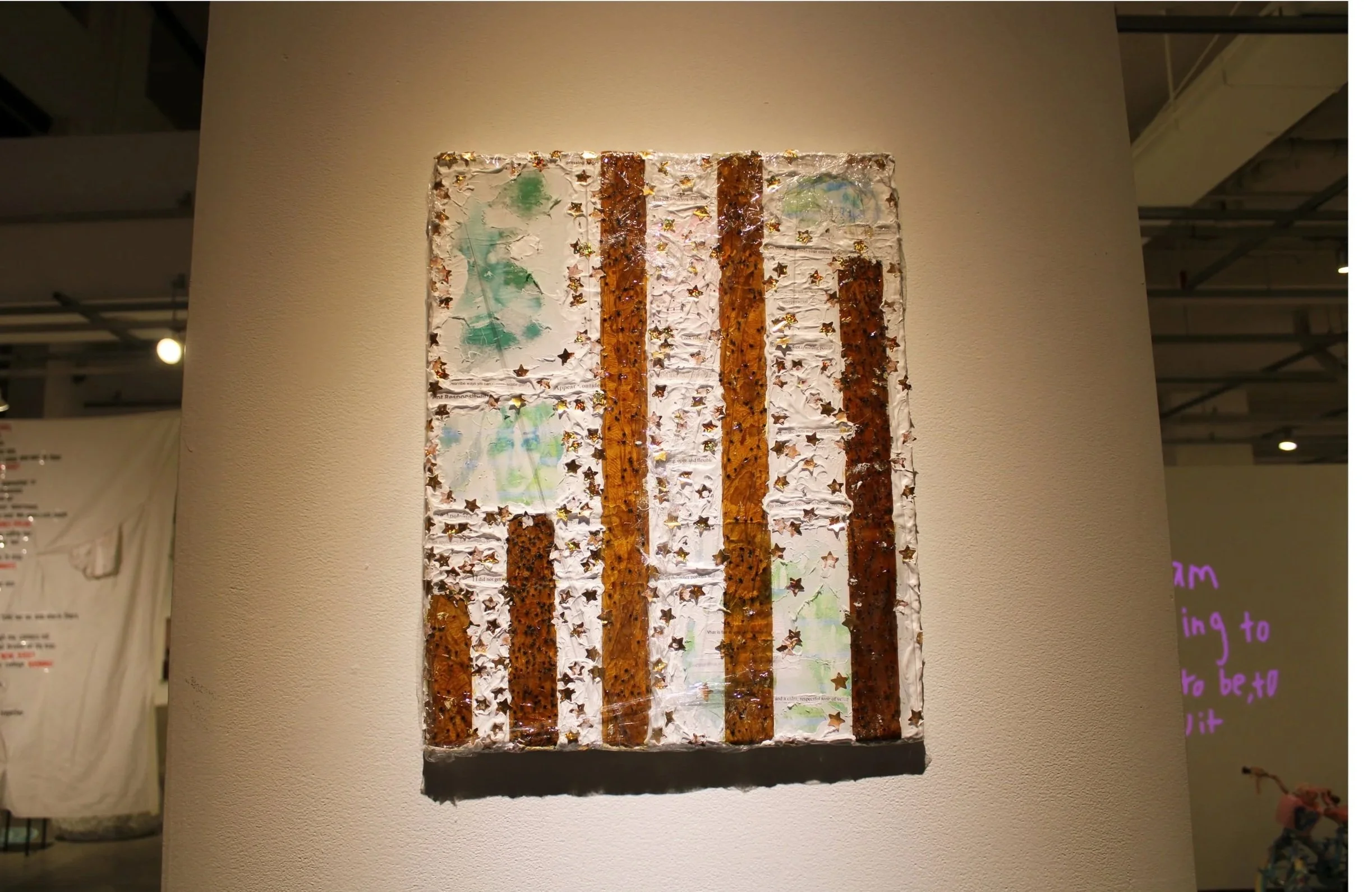 Mixed media artwork on canvas featuring vertical stripes in shades of brown and white, decorated with gold star-shaped confetti.