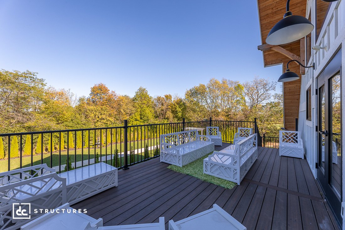 A deck made from composite decking material, overlooking a forested region.
