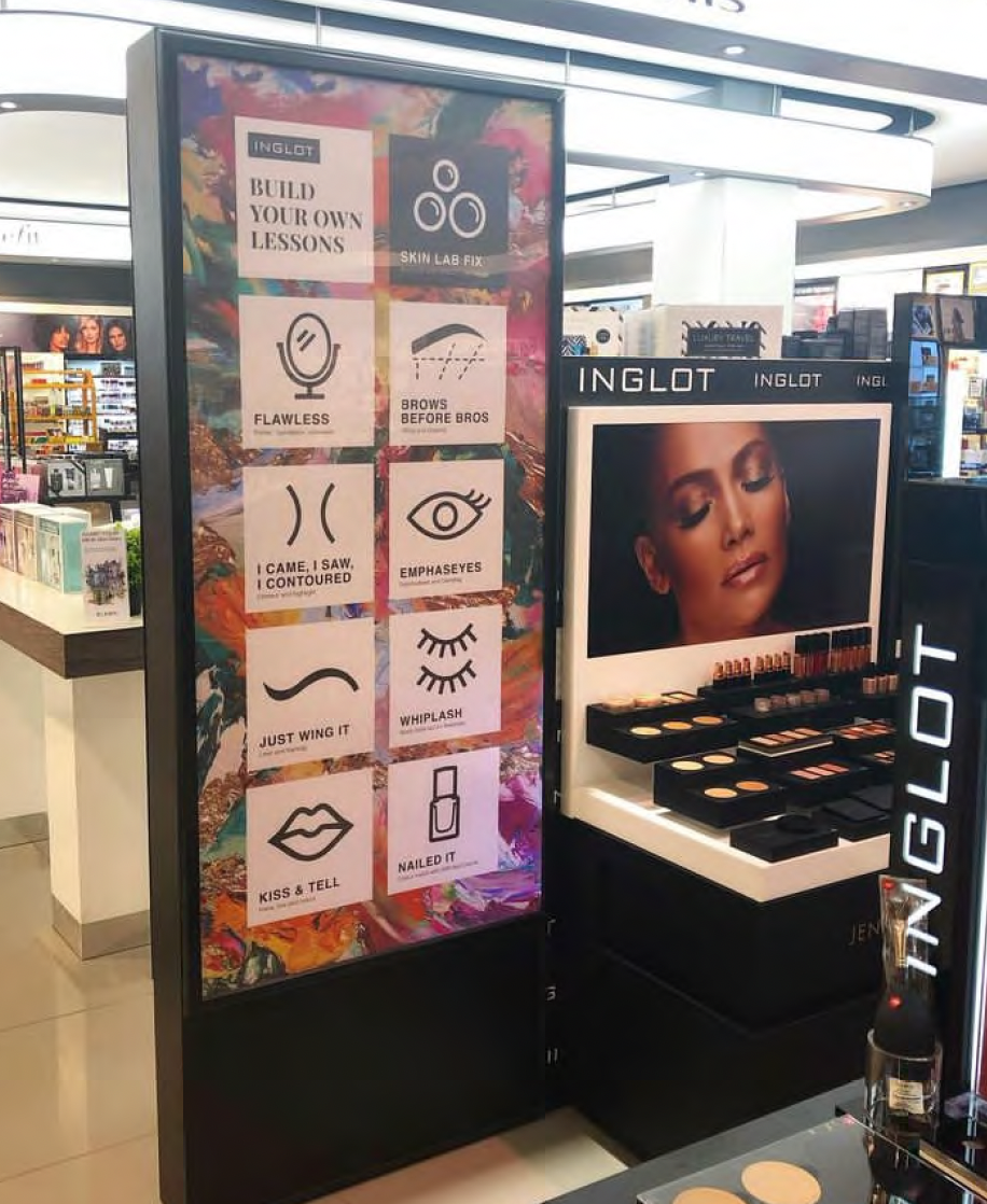 Display stand lightbox with makeup products and a sign with humorous instructions for eye makeup. Designs for in-store collateral 