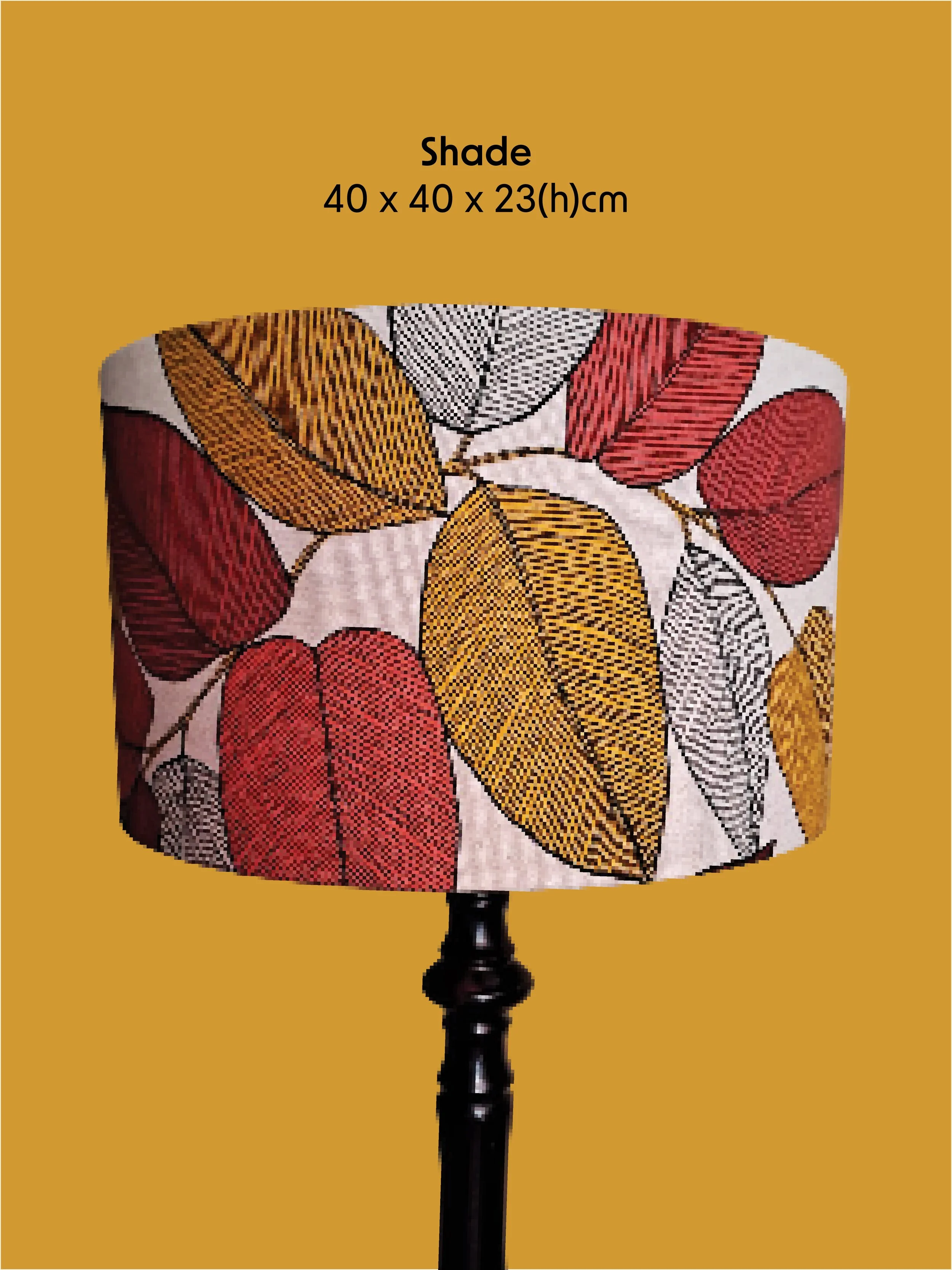 A decorative lampshade with a colorful, leaf pattern sits on a black stand against a mustard yellow background.  I designed a variety of colourful background lampshade social media posts.