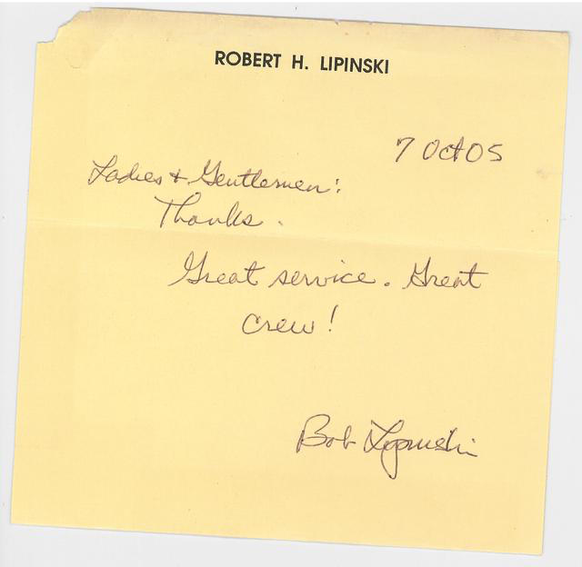 A yellow note card with handwritten message and typed name at top. The handwritten message reads: "Ladies & Gentlemen! Thanks. Great service. Great crew!" and is signed "Bob Lapinski." The typed name at top is "ROBERT H. LIPINSKI." The date written i