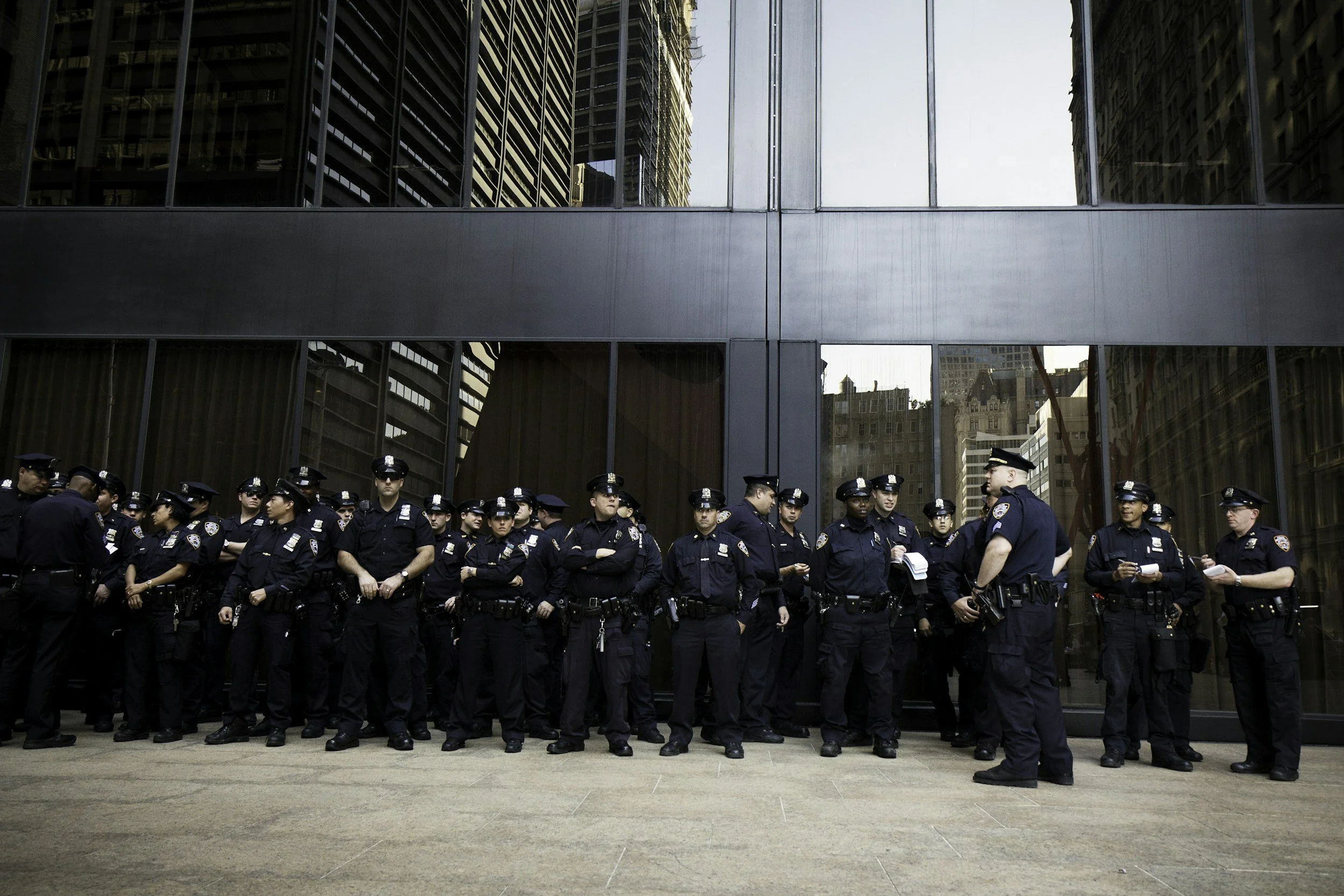 Police officers gathered outside a municipal building representing city and borough customers.