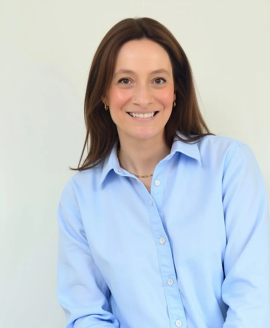 Therapist Sarah smiling at camera with blue collared shirt
