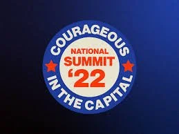 Button with text 'Courageous in the Capital' and 'National Summit '22' in red, blue, and white colors.