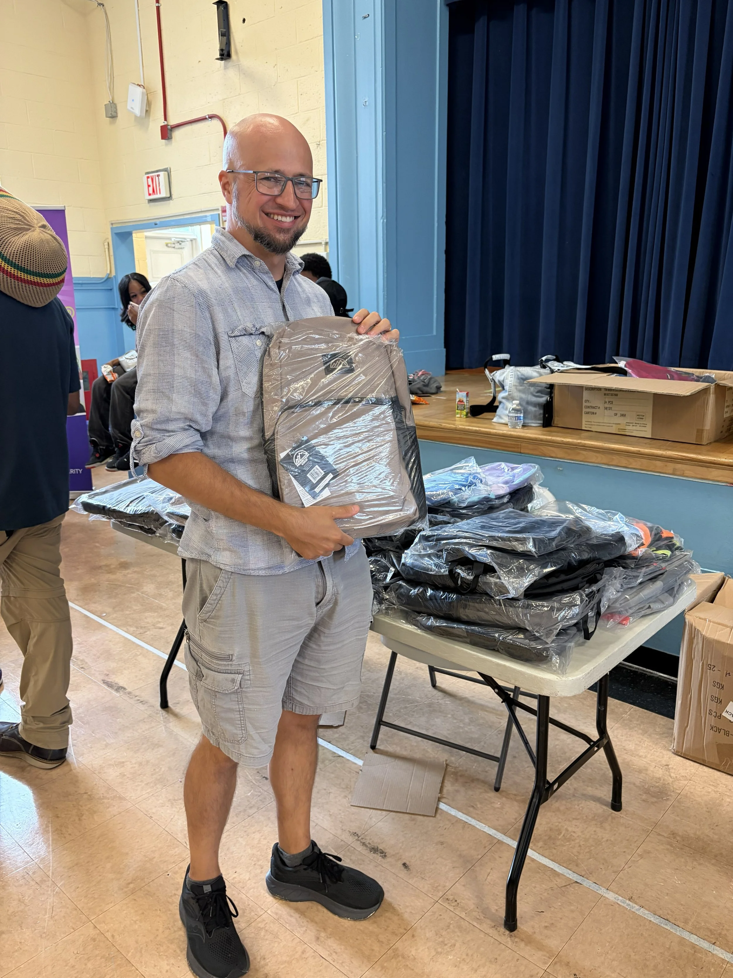 Jon helping distribute backpacks and school supplies at Bunker Hill at the Ward 5 EEC event