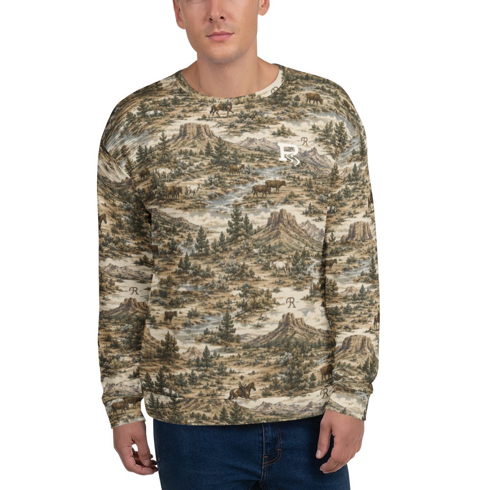 A man wearing a long-sleeved sweatshirt with a mountain and forest landscape pattern, featuring animals like bears and horses.