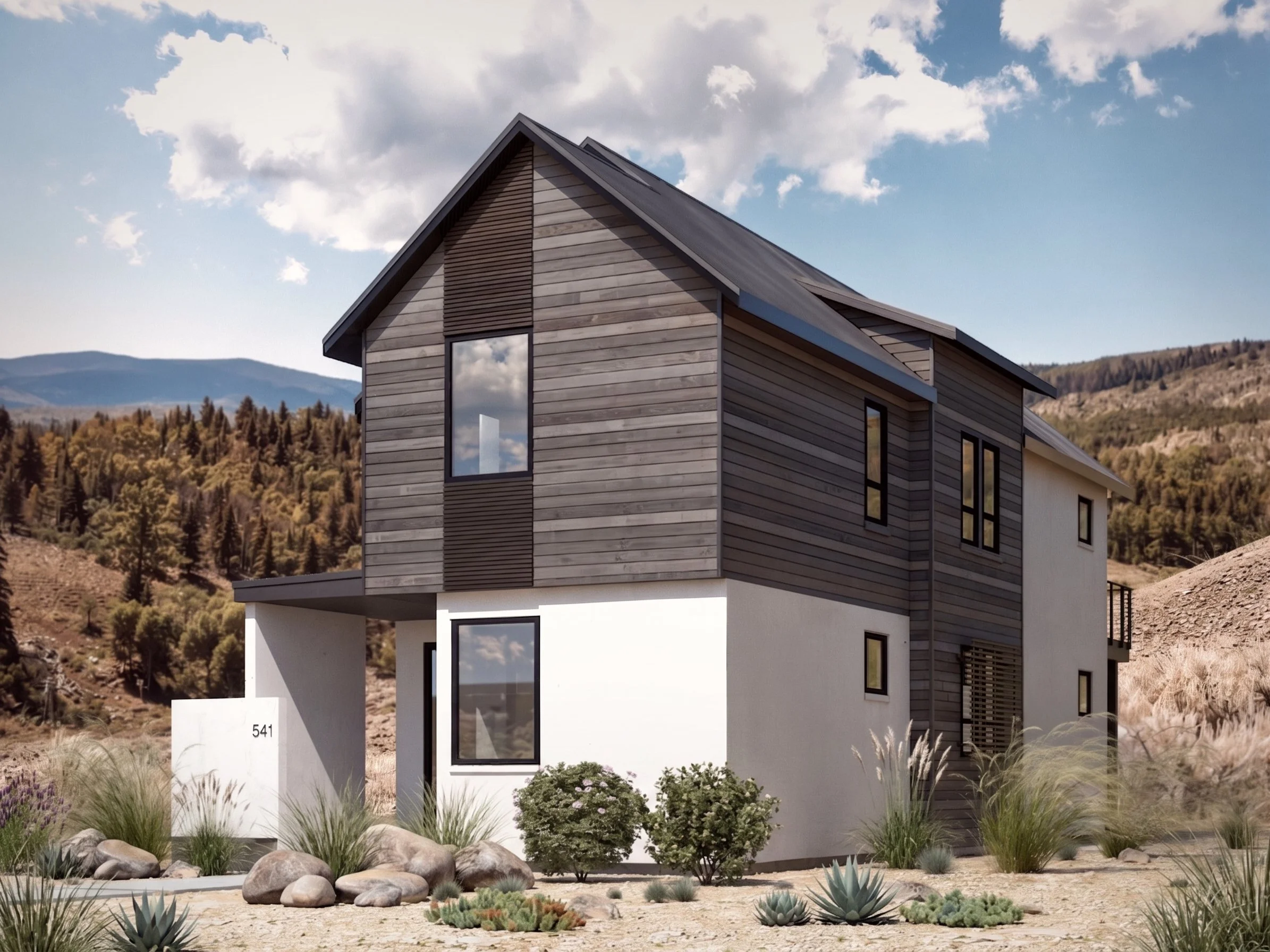 Modern two-story house with a mix of wood and white siding, large windows, and a sloped roof, set against a mountainous landscape with trees and a partly cloudy sky. The front yard features desert plants and rocks.
