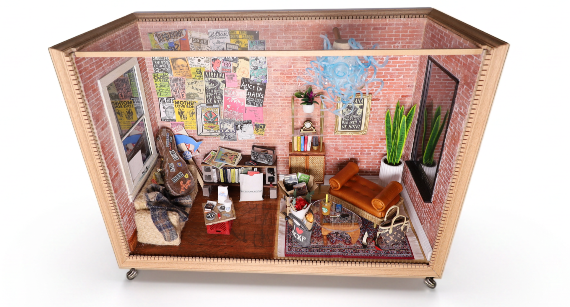 Miniature room with brick walls, decorated with posters, featuring a sitting area with a rug, coffee table, sofa, and chair, along with plants, bookshelf, and various objects and decorations.