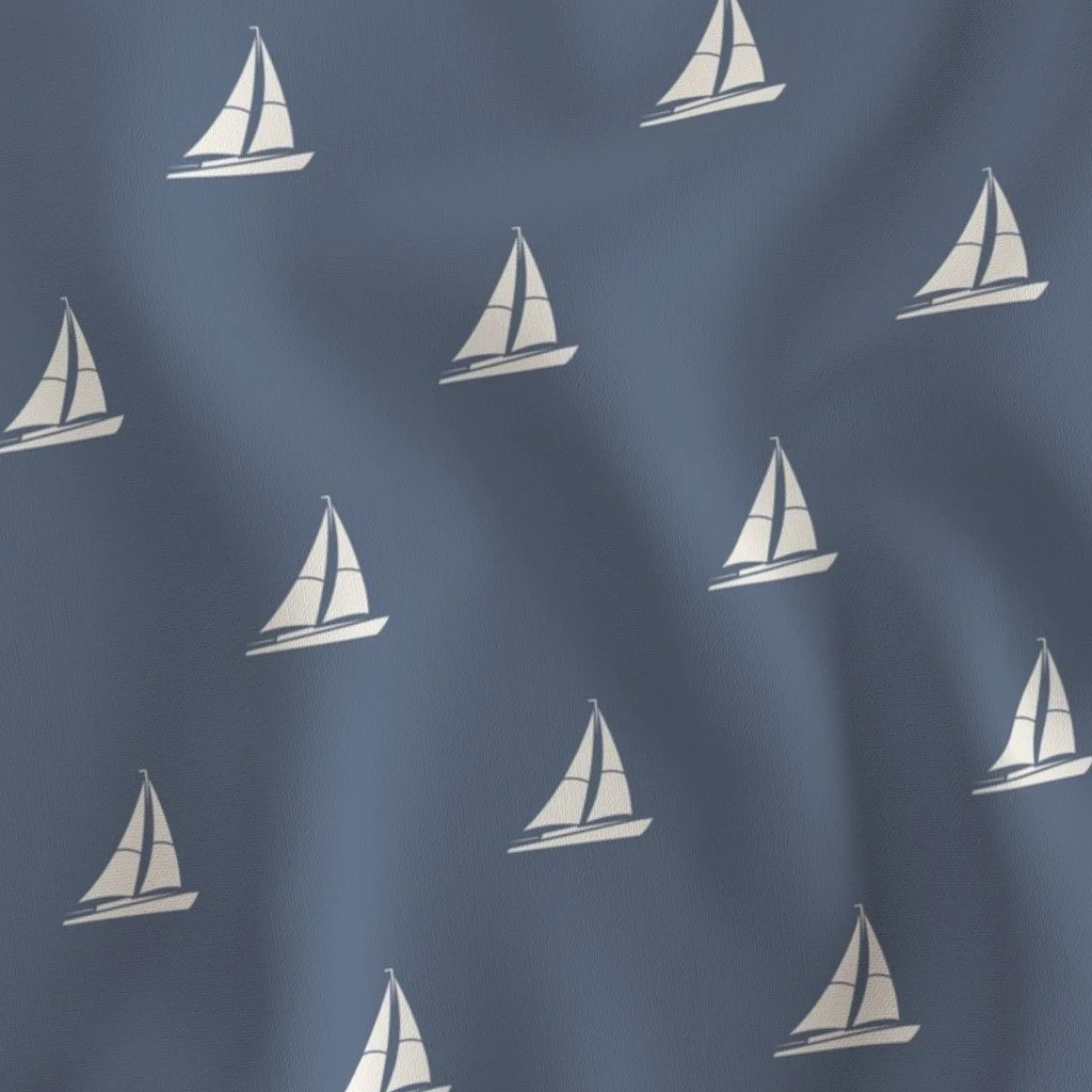 Pattern of white sailboats on a blue background.