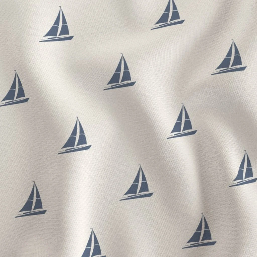 Pattern of blue sailboats on a light-colored fabric background.