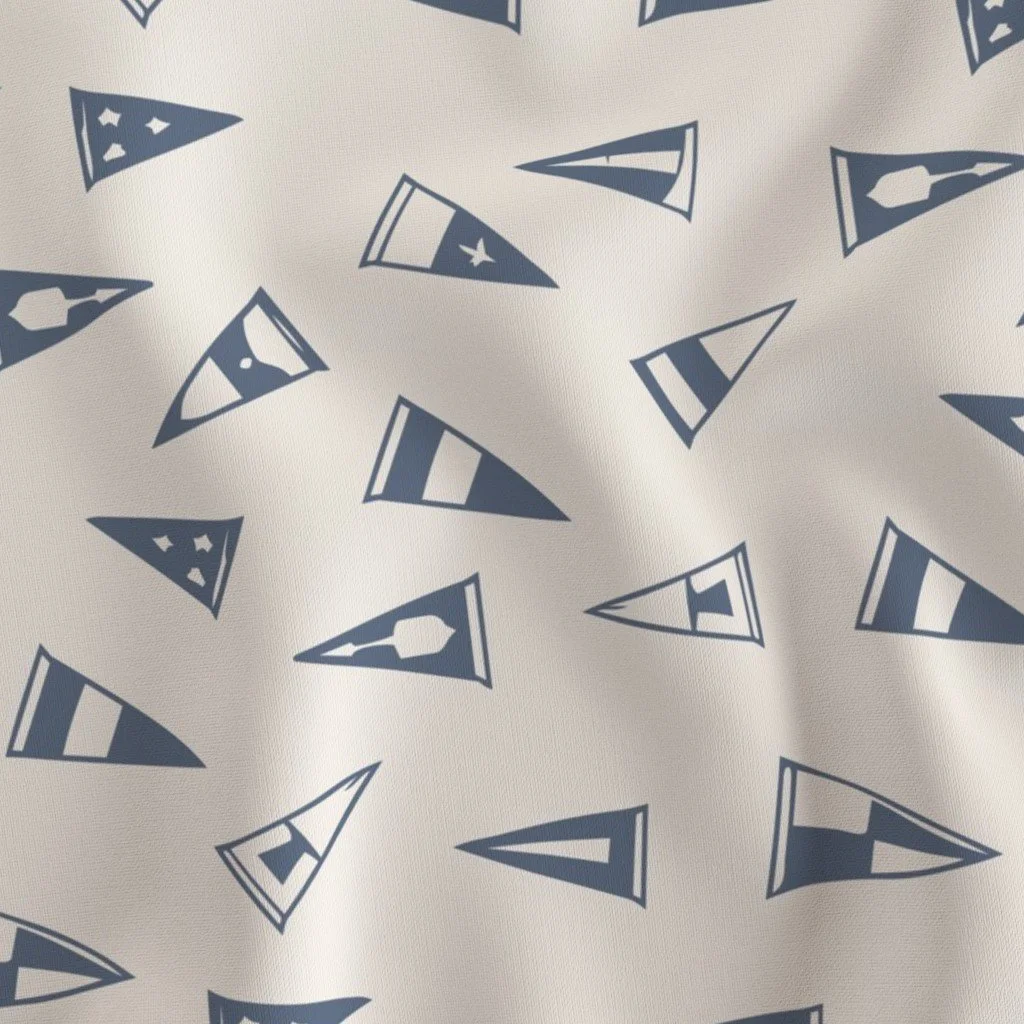 A fabric with a pattern of navy blue pennant banners featuring stars and stripes on a white background.