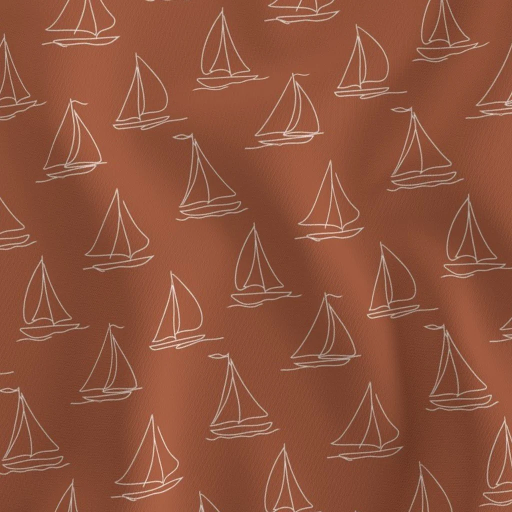 Pattern of white sailboats on a brown background.