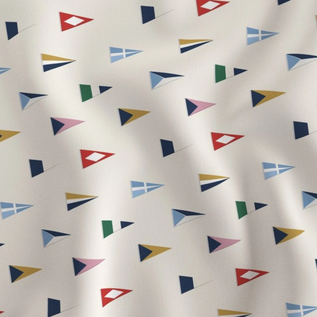 Pattern of small, colorful, geometric sailboat shapes on a white background.