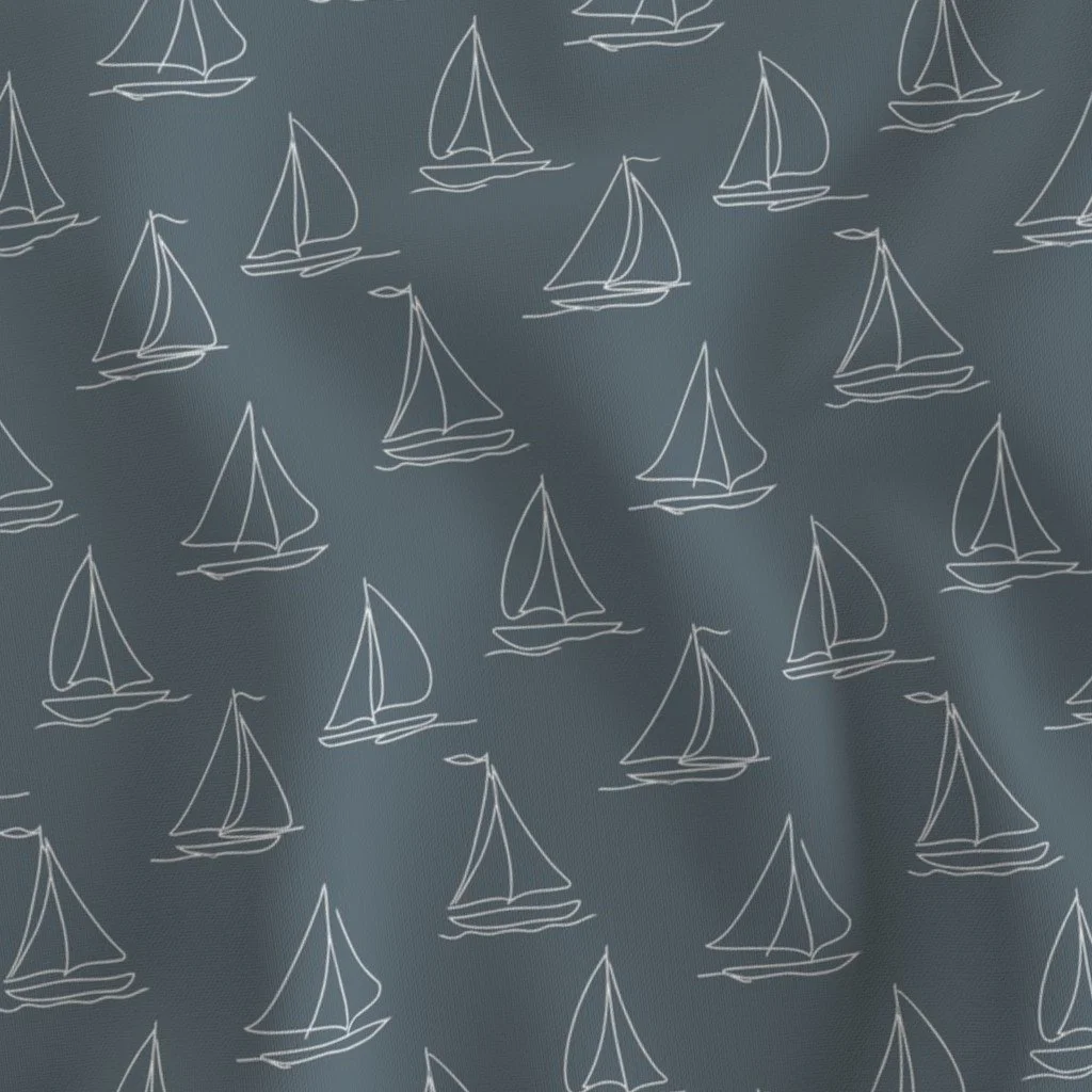 Pattern of white sailboats on a dark background.