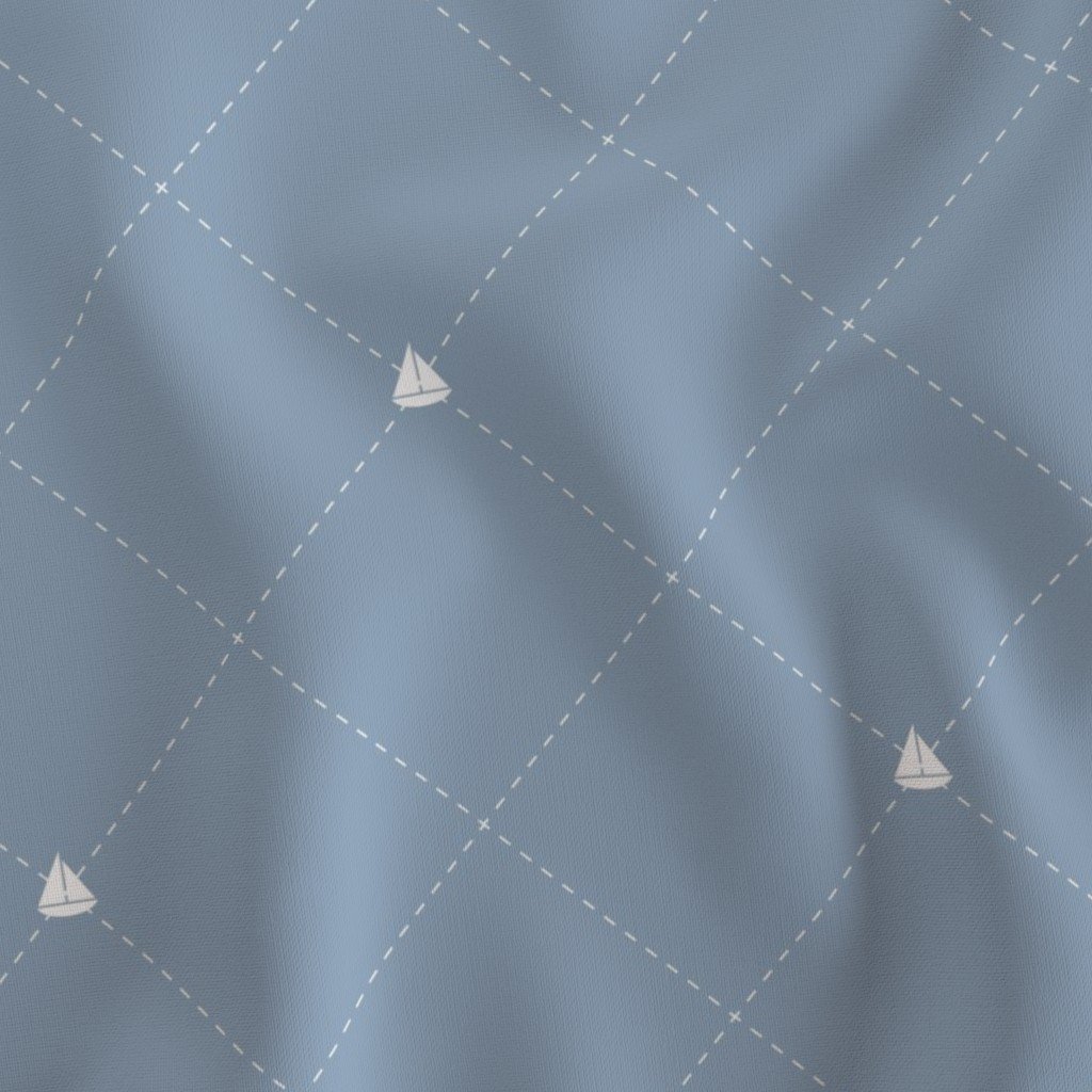 Light blue fabric with a pattern of small white sailboats and dashed lines forming diamond shapes.