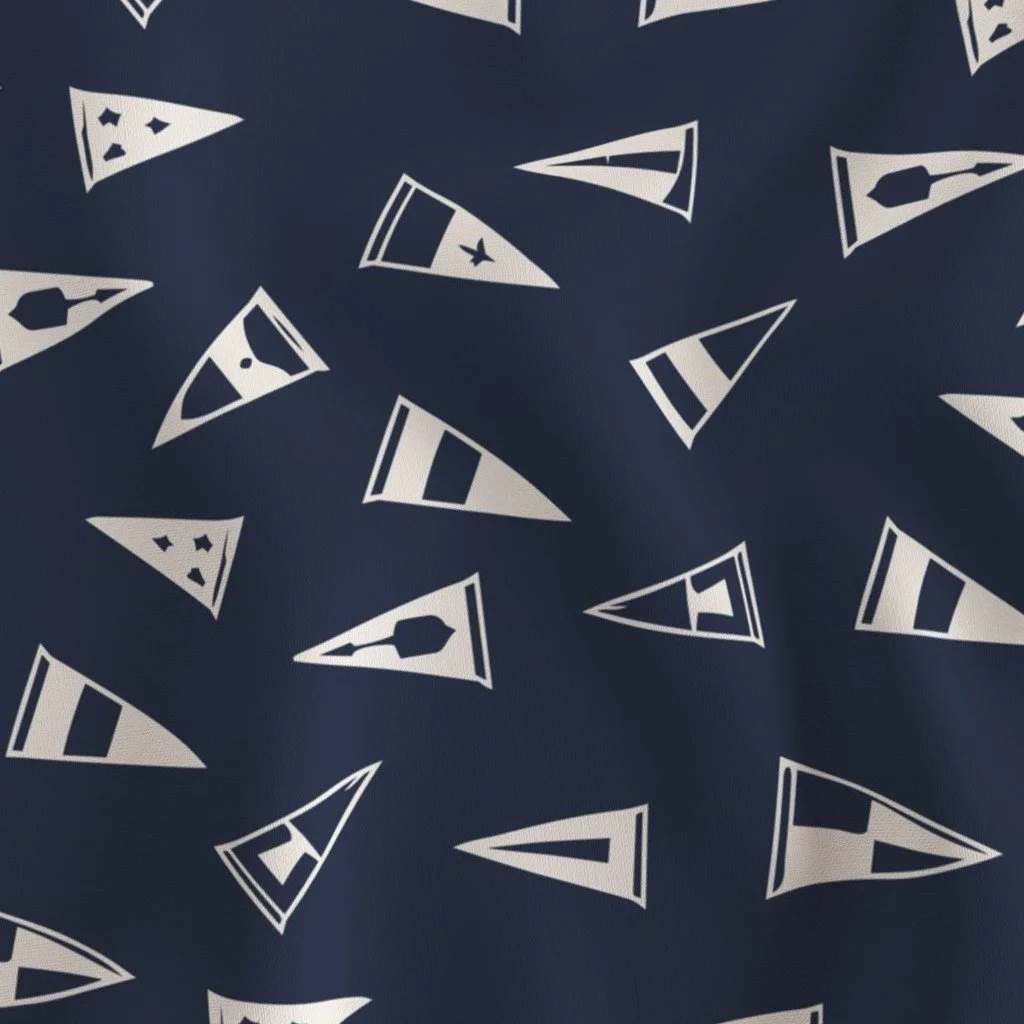 Dark blue fabric with scattered sailboat patterns in white.