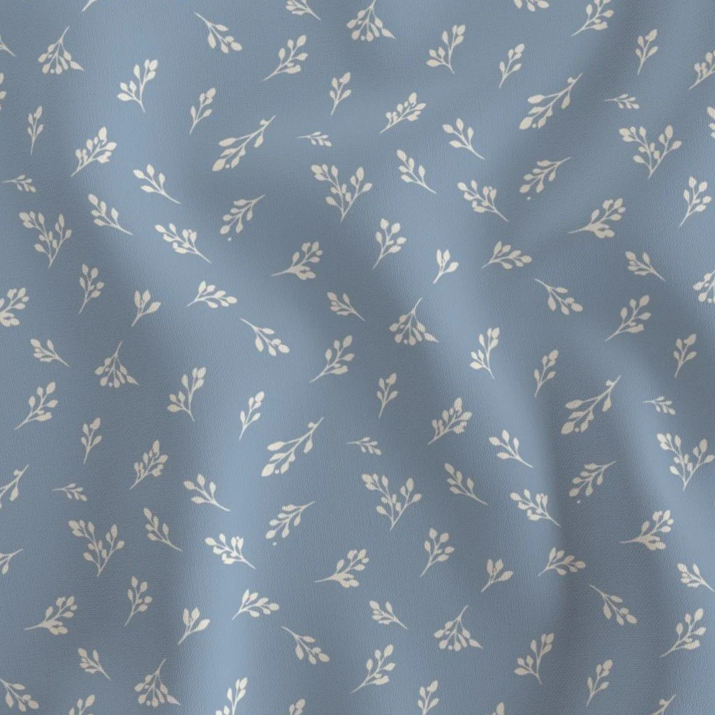 Light blue fabric with small white leafy branch patterns.