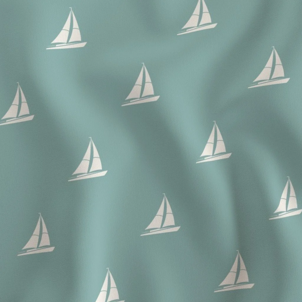 Light blue fabric with white sailboat pattern.